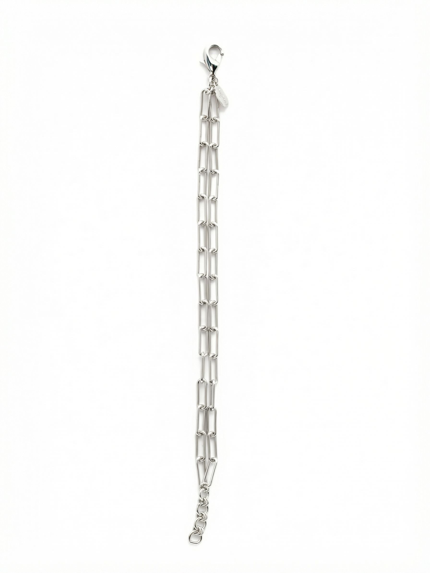 Rory Tennis Bracelet - 4BEV5PDMTL - <p>Two parallel rows of elongated paperclip links bring an architectural yet airy feel to your wrist stack. The bare metallic finish catches natural light from every angle, relying purely on the geometry of the double chain to make a quiet impression. It drapes lightly, moving with your natural rhythm throughout the day. An integrated extension chain allows you to tailor the drape, whether you prefer it worn close or gently slipping down your arm.</p><ul>
<li>Double parallel rows of elongated paperclip links</li>
<li>Pure metallic design with open geometric construction</li>
<li>Lobster claw clasp</li>
<li>3/4-inch adjustable extension chain</li>
<li>Protective e-coat finish for lasting wear</li>
<li>Includes signature organza pouch for gifting and travel</li>
</ul>