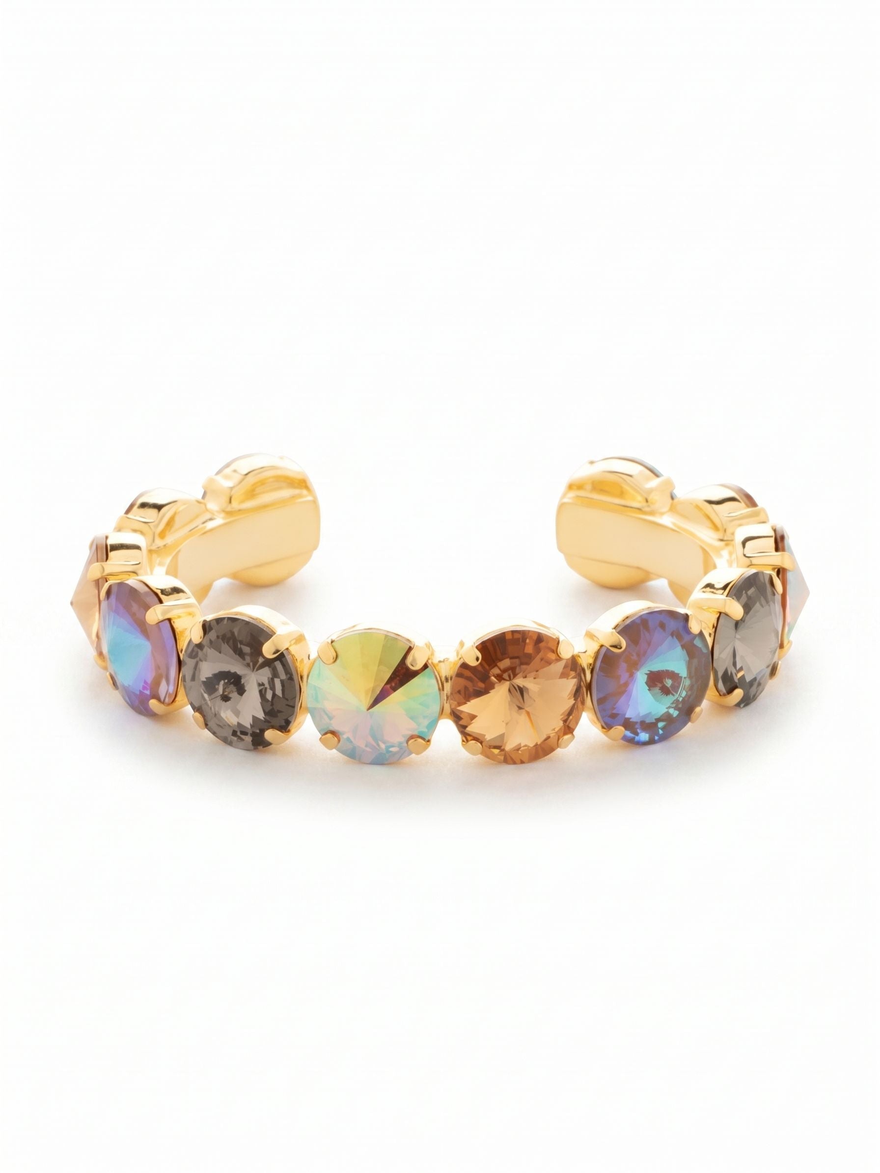 Nadine Cuff Bracelet - 4BEZ17BGHNB - <p>A line of substantial, round-cut crystals circles the wrist in rich, whiskey-toned hues. Black diamond, warm cappuccino, and iridescent colorado stones are set closely together in bright gold-tone metal. The open cuff design slips right on and stays anchored, offering a comfortable, customized fit without the fuss of a clasp. It carries enough visual weight to anchor an evening look on its own, yet layers effortlessly with finer gold chains for daytime wear.</p><ul>
<li>Continuous row of oversized round-cut crystals</li>
<li>Rich gradient of warm honey and deep charcoal hues</li>
<li>Adjustable open cuff slides on easily</li>
<li>Protective e-coat finish for lasting wear</li>
<li>Includes signature organza pouch for gifting and travel</li>
</ul>
