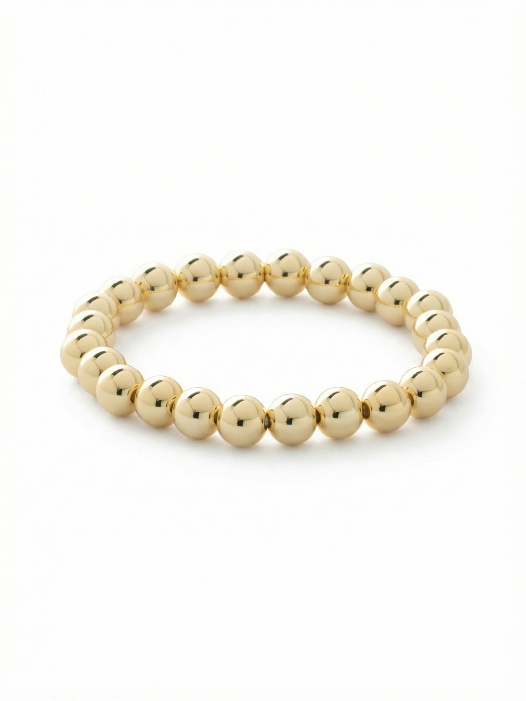 Zola Stretch Bracelet - 4BFJ20BGMTL - <p>Polished spheres of bright gold-tone metal form a continuous, highly reflective loop around the wrist. The flexible stretch construction rolls on smoothly, allowing the bracelet to sit comfortably next to a daily watch or a stack of crystal cuffs. Relying purely on shape and shine, this bare metallic design serves as a warm, grounding element that catches the light effortlessly as you move through your day.</p><ul>
<li>Continuous loop of smooth, highly reflective spherical beads</li>
<li>Substantial bead scale creates a bold metallic line</li>
<li>Protective e-coat finish for lasting wear</li>
<li>Stretch easy slip-on design</li>
<li>Includes signature organza pouch for gifting and travel</li>
</ul>