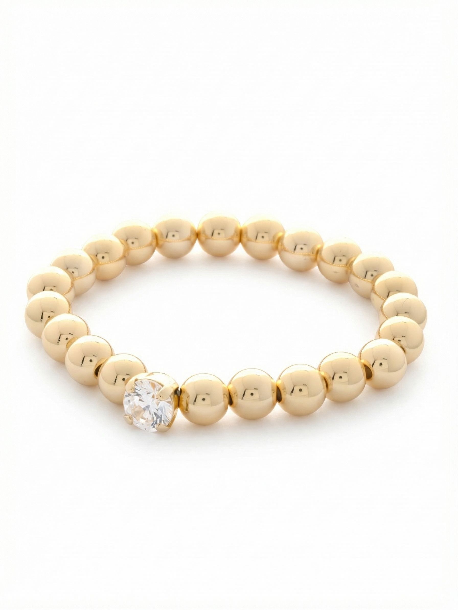 Single Crystal Stretch Bracelet - 4BFJ21BGCRY - <p>A continuous line of polished metallic spheres offers a sleek foundation for a single, brilliant round-cut crystal. The stretch construction rolls effortlessly over your hand, making it a natural choice for busy mornings. Worn alone, it provides a quiet flash of light at your cuff. Layered with other pieces, the smooth beads create a reflective contrast to your more complex jewelry, offering a grounding element to your daily stack.</p><ul>
<li>Single focal round-cut crystal interrupting a smooth metallic line</li>
<li>Reflective spherical bead construction for high-shine contrast</li>
<li>Stretch easy slip-on design</li>
<li>Protective e-coat finish for lasting wear</li>
<li>Includes signature organza pouch for gifting and travel</li>
</ul>
