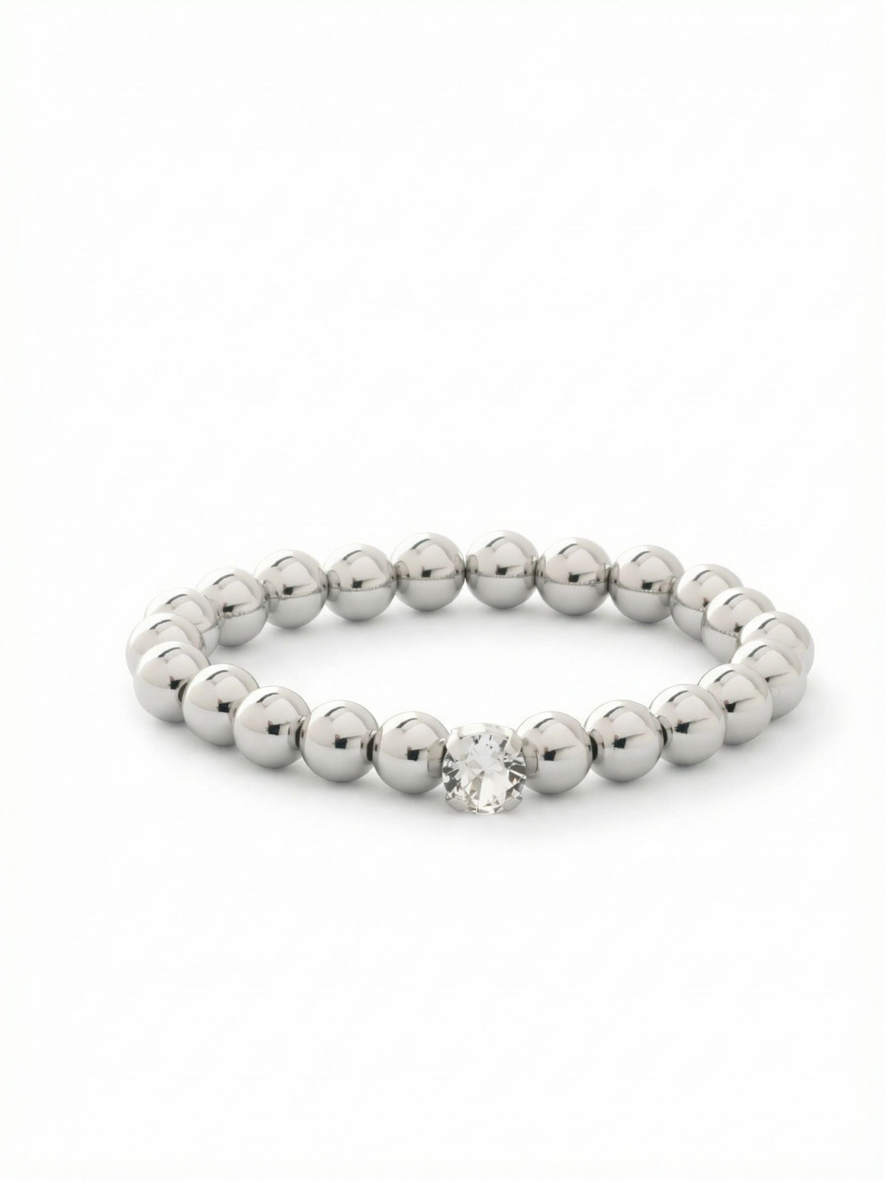 Single Crystal Stretch Bracelet - 4BFJ21PDCRY - <p>Polished metal spheres offer a sleek, reflective contrast to a single, brightly faceted round crystal. Designed to slip on effortlessly, the stretch construction means you never have to fumble with a clasp on your way out the door. The smooth beads carry a comfortable weight that warms gently against the skin as you move. It easily anchors a daily stack of chains and cuffs or holds its own alongside your favorite watch.</p><ul>
<li>Highly polished spherical beads create a sleek continuous reflection</li>
<li>Single large round-cut crystal provides a focused point of light</li>
<li>Stretch easy slip-on design</li>
<li>Protective e-coat finish for lasting wear</li>
<li>Includes signature organza pouch for gifting and travel</li>
</ul>
