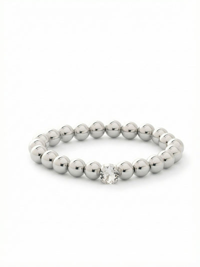 Single Crystal Stretch Bracelet - 4BFJ21PDCRY - <p>Polished metal spheres offer a sleek, reflective contrast to a single, brightly faceted round crystal. Designed to slip on effortlessly, the stretch construction means you never have to fumble with a clasp on your way out the door. The smooth beads carry a comfortable weight that warms gently against the skin as you move. It easily anchors a daily stack of chains and cuffs or holds its own alongside your favorite watch.</p><ul>
<li>Highly polished spherical beads create a sleek continuous reflection</li>
<li>Single large round-cut crystal provides a focused point of light</li>
<li>Stretch easy slip-on design</li>
<li>Protective e-coat finish for lasting wear</li>
<li>Includes signature organza pouch for gifting and travel</li>
</ul>