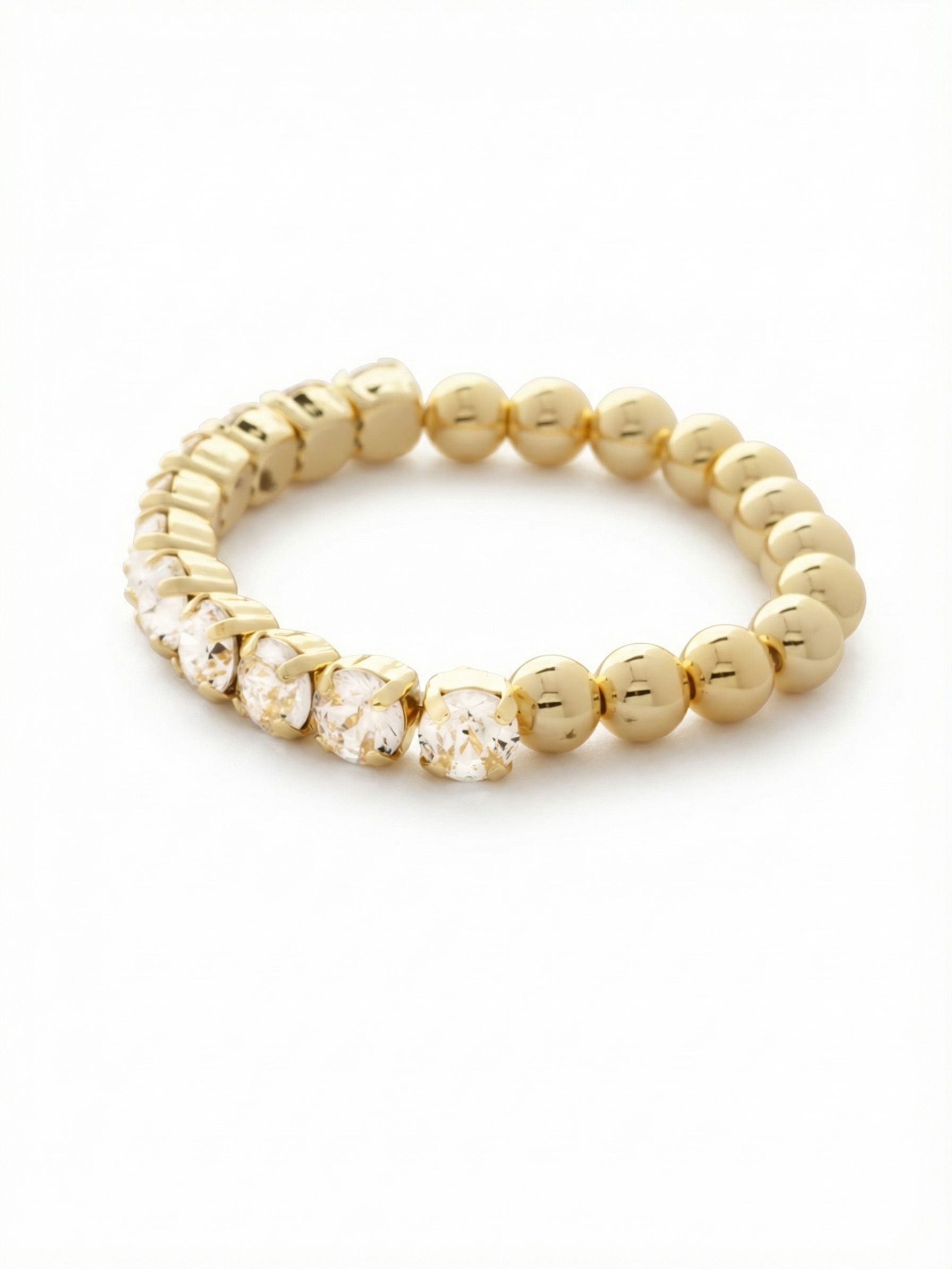 Crystal Zola Stretch Bracelet - 4BFJ40BGCRY - <p>Half sleek gold beads, half brilliant round-cut crystals. This stretch bracelet bridges the gap between everyday ease and considered detail. The smooth metal spheres provide a grounding contrast to the bright, light-catching facets of the stones. Designed without a clasp, it slips effortlessly over your hand for immediate wearability. It holds its own worn solo with a rolled-up cuff, or adds textural interest when mixed into your daily stack.</p><ul>
<li>Half-and-half design mixing smooth metallic spheres with faceted clear crystals</li>
<li>Substantial round-cut stones offer significant visual presence</li>
<li>Stretch easy slip-on design</li>
<li>Protective e-coat finish for lasting wear</li>
<li>Includes signature organza pouch for gifting and travel</li>
</ul>