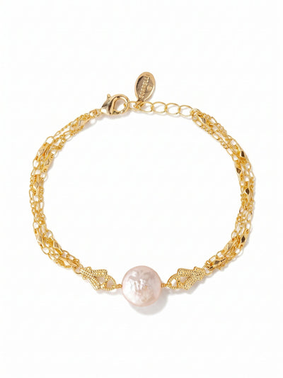 Aislin Tennis Bracelet - 4BGK4BGMDP - <p>A slender chain anchors a single white coin pearl to create a quiet focal point on the arm. The distinct flat profile of the pearl feels weightless and moves naturally as you go about your day. Offering a subtle wash of warmth, this delicate piece works beautifully on its own or layered among heavier links and vintage watches. An extension chain allows you to easily adjust the drape for a tailored, comfortable fit.</p><ul>
<li>Single coin pearl station creates a minimalist focal point</li>
<li>Delicate profile designed for seamless everyday layering</li>
<li>Lobster claw clasp</li>
<li>3/4-inch adjustable extension chain</li>
<li>Protective e-coat finish for lasting wear</li>
<li>Includes signature organza pouch for gifting and travel</li>
</ul>
