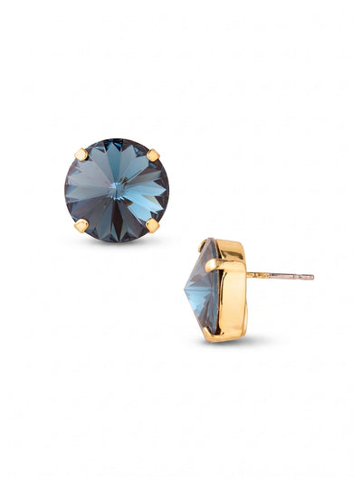 Nadine Stud Earrings - 4EEZ17BGMON - <p>A single, deeply faceted round crystal anchors these stud earrings. The deep blue Montana stone catches the light from across a table, while the minimalist bright gold-tone setting lets the geometry of the cut take focus. At over half an inch wide, they offer a substantial presence that reads clearly at conversation distance. We include an oversized comfort clutch to ensure the setting stays secure, upright, and perfectly balanced from morning until evening.</p><ul>
<li>Deeply faceted round crystal with a minimal four-prong setting</li>
<li>Substantial scale that reads clearly at a conversational distance</li>
<li>Post with oversized comfort-clutch back</li>
<li>Protective e-coat finish for lasting wear</li>
<li>Includes signature organza pouch for gifting and travel</li>
</ul>