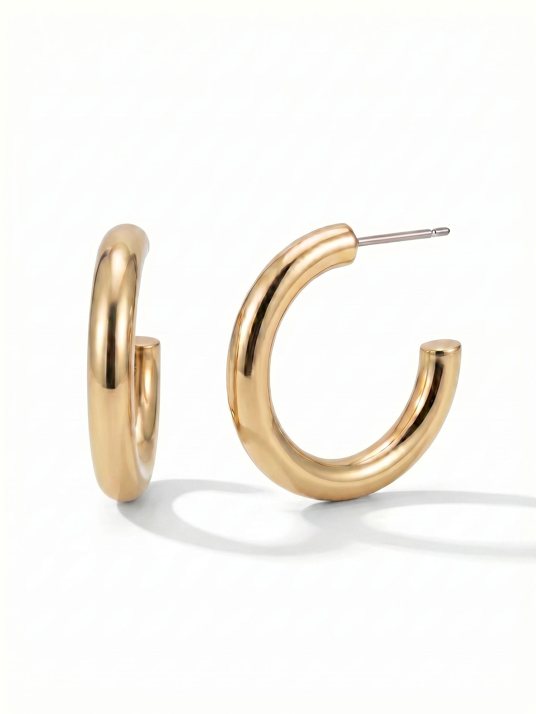 Keeley Hoop Earrings - 4EFF1BGMTL - <p>The Keeley Hoop brings quiet polish to your daily rotation. Designed with a generous tubular profile, the bright metallic finish catches daylight smoothly with every turn of your head. At just over an inch and a half, these earrings offer the visual impact of a bold shape without the heavy pull. The secure post and pressure-fit comfort back keep them safely anchored, transitioning effortlessly from morning routines to late dinners.</p><ul>
<li>Generous tubular shape creates bold volume with a minimalist silhouette</li>
<li>Smooth reflective surface catches light continuously from all angles</li>
<li>Hoop earring</li>
<li>Protective e-coat finish for lasting wear</li>
<li>Includes signature organza pouch for gifting and travel</li>
</ul>