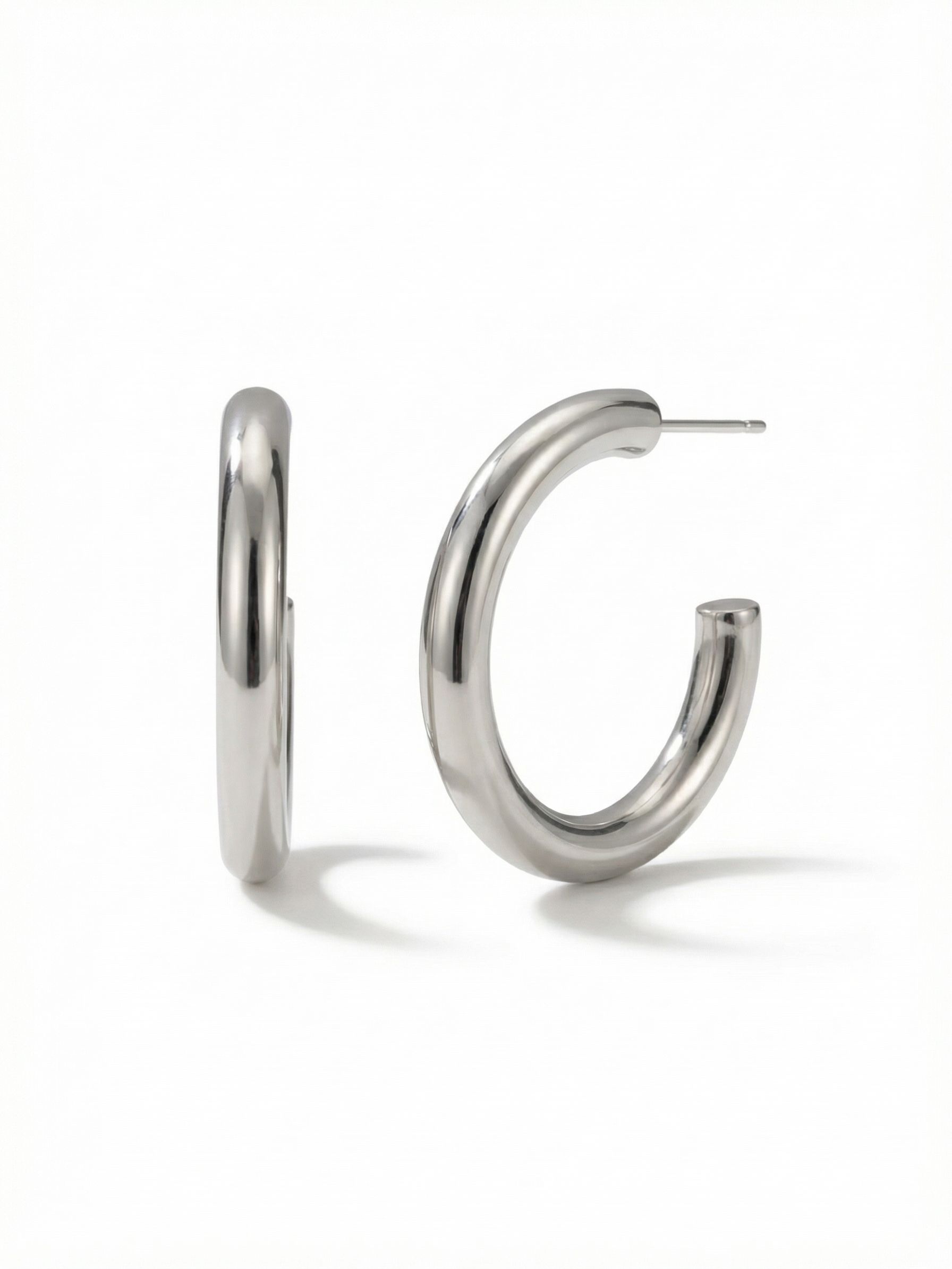 Keeley Hoop Earrings - 4EFF1PDMTL - <p>These smooth, tubular hoops bring a quiet polish to your everyday rotation. Measuring just over an inch and a half, the high-shine palladium finish catches light naturally with the turn of your head. The open C-shape silhouette offers substantial visual volume without feeling heavy. An oversized comfort clutch ensures the post stays secure, keeping the hoop balanced and upright from early morning coffee through evening routines.</p><ul>
<li>Thick tubular design with a highly reflective surface</li>
<li>Open C-shape silhouette for balanced visual volume</li>
<li>Hoop earring</li>
<li>Protective e-coat finish for lasting wear</li>
<li>Includes signature organza pouch for gifting and travel</li>
</ul>