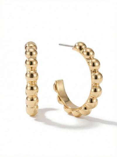 Bauble Hoop Earrings - 4EFL12BGMTL - <p>A sculptural update to the everyday hoop, these earrings arrange polished metallic spheres into a clean open curve. The bright gold finish catches light continuously as you move, giving them a bold presence that reads clearly at conversation distance. Built with a flat inner profile, they deliver visual volume without a heavy feel. Secured by a post and an oversized comfort clutch, they stay flush and perfectly balanced from morning to night.</p><ul>
<li>Continuous row of polished spheres creates a highly reflective surface</li>
<li>Flat inner structure provides bold visual volume with a lightweight feel</li>
<li>Post with oversized comfort-clutch back</li>
<li>Protective e-coat finish for lasting wear</li>
<li>Includes signature organza pouch for gifting and travel</li>
</ul>
