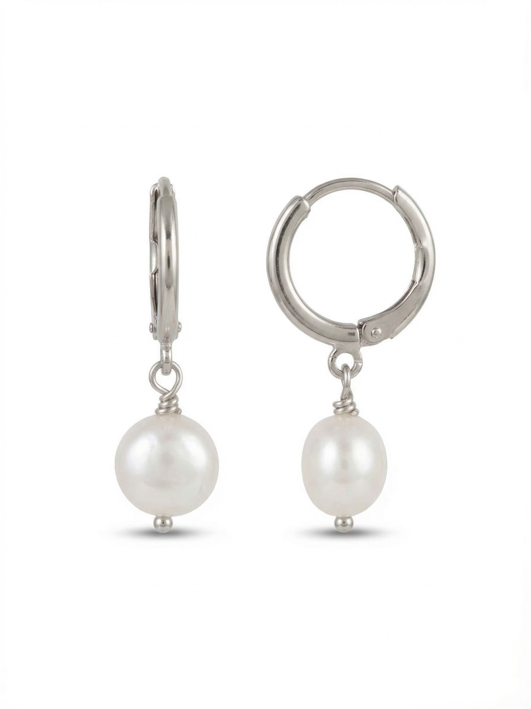 Pearl Huggie Hoop Earrings - 4EFZ11PDMDP - <p>A quiet take on a classic silhouette. The sleek palladium huggie secures cleanly, creating a polished foundation for the single round pearl suspended just beneath. The pearl offers gentle, natural movement with every turn of the head, catching soft light. A delicate wire-wrapped detail connects the pearl to the hoop, adding a touch of artisanal texture to the clean lines. Lightweight and balanced, these are the reliable staples that transition seamlessly through your daily routine.</p><ul>
<li>Single round pearl suspended for natural daily movement</li>
<li>Delicate wire-wrapped detailing above the pearl</li>
<li>Huggie hoop with click-shut closure</li>
<li>Protective e-coat finish for lasting wear</li>
<li>Includes signature organza pouch for gifting and travel</li>
</ul>