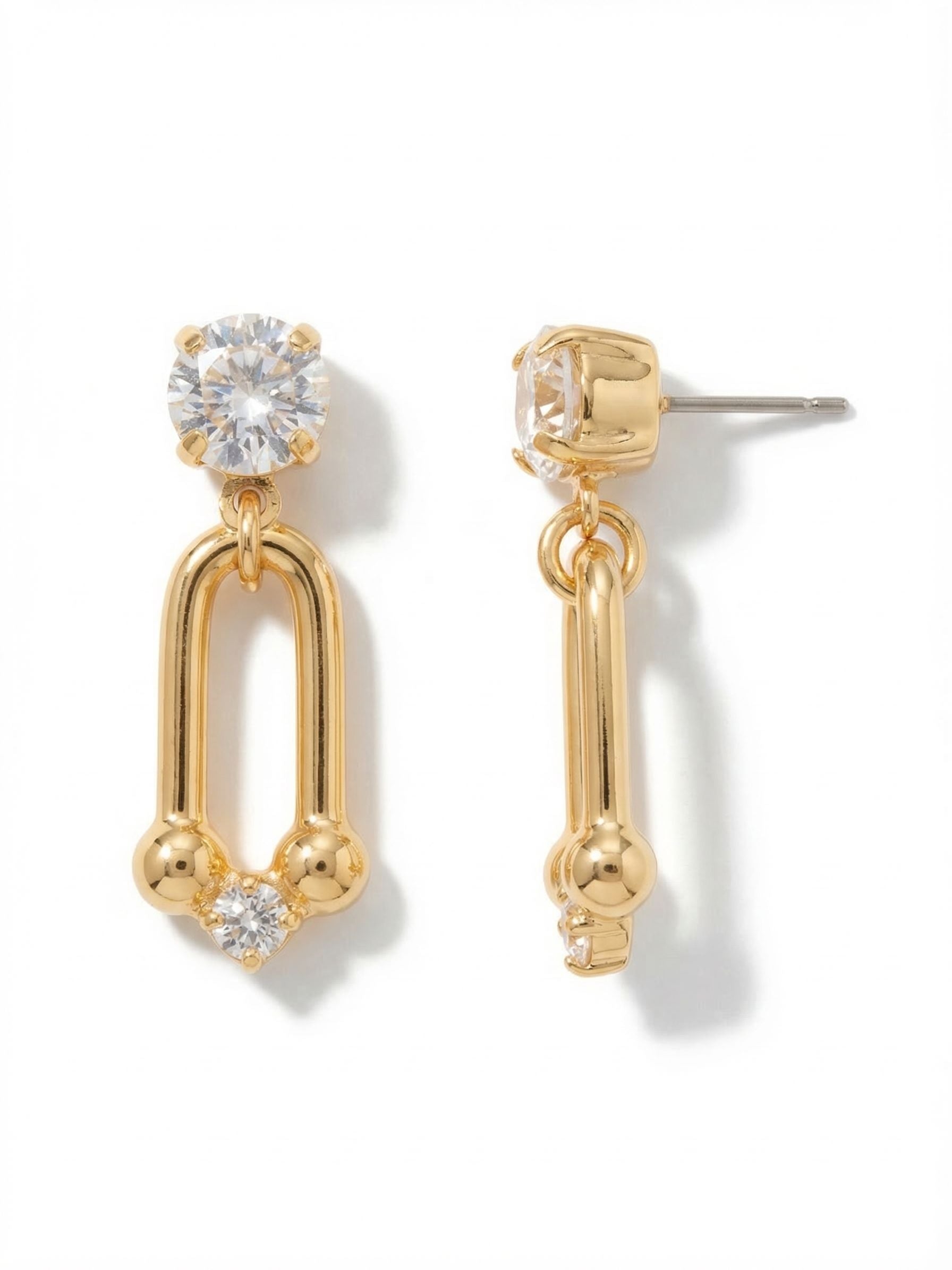 Tinley Dangle Earrings - 4EGI2BGCRY - <p>A crisp clear crystal anchors this earring at the post, giving way to an elongated metal U-link that swings freely with every turn of the head. The architectural loop ends with a subtle cluster of rounded hardware accents and a single smaller crystal catchlight at the base. Measuring just an inch and a half, the scale is intentional. It offers visible movement and shine without heavy weight, while an oversized comfort clutch keeps the design securely balanced.</p><ul>
<li>Articulated metal loop provides fluid motion</li>
<li>Balanced mix of prominent hardware and subtle round-cut crystal accents</li>
<li>Post with oversized comfort-clutch back</li>
<li>Protective e-coat finish for lasting wear</li>
<li>Includes signature organza pouch for gifting and travel</li>
</ul>