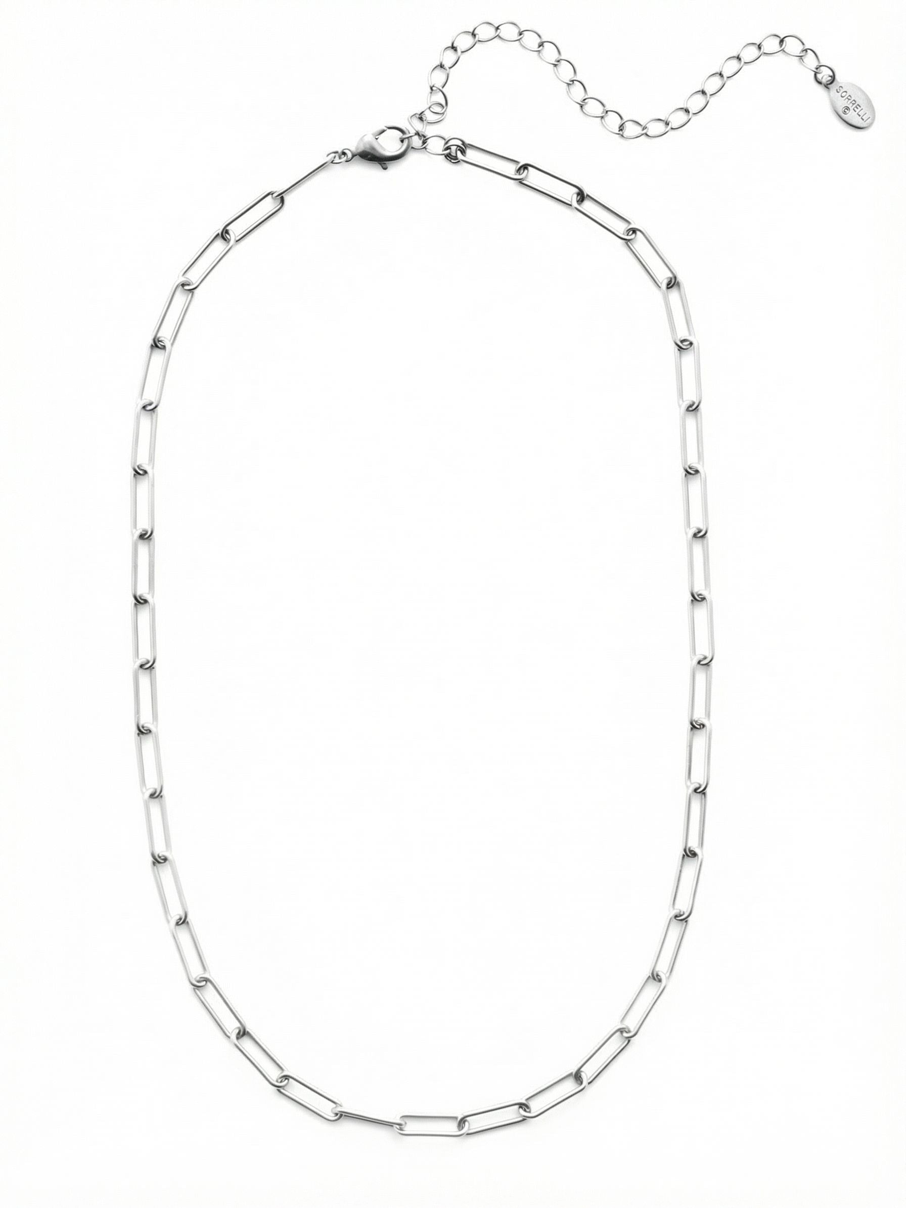 Jacinda Tennis Necklace - 4NES13RHCRY - <p>The elongated links of this paperclip chain catch the light with a quiet, polished gleam. Designed as a versatile foundational piece, it rests lightly along the collarbone with an open, airy structure that brings modern texture to your neckline. It holds its own as a solo accent while easily serving as the starting point for a layered look. The built-in extension chain allows you to adjust the drape to suit different collars, seamlessly adapting to your daily rotation.</p><ul>
<li>Elongated open links create an airy structural texture</li>
<li>Sleek interlocking profile designed for seamless layering</li>
<li>Lobster claw clasp</li>
<li>4-inch adjustable extension chain</li>
<li>Protective e-coat finish for lasting wear</li>
<li>Includes signature organza pouch for gifting and travel</li>
</ul>