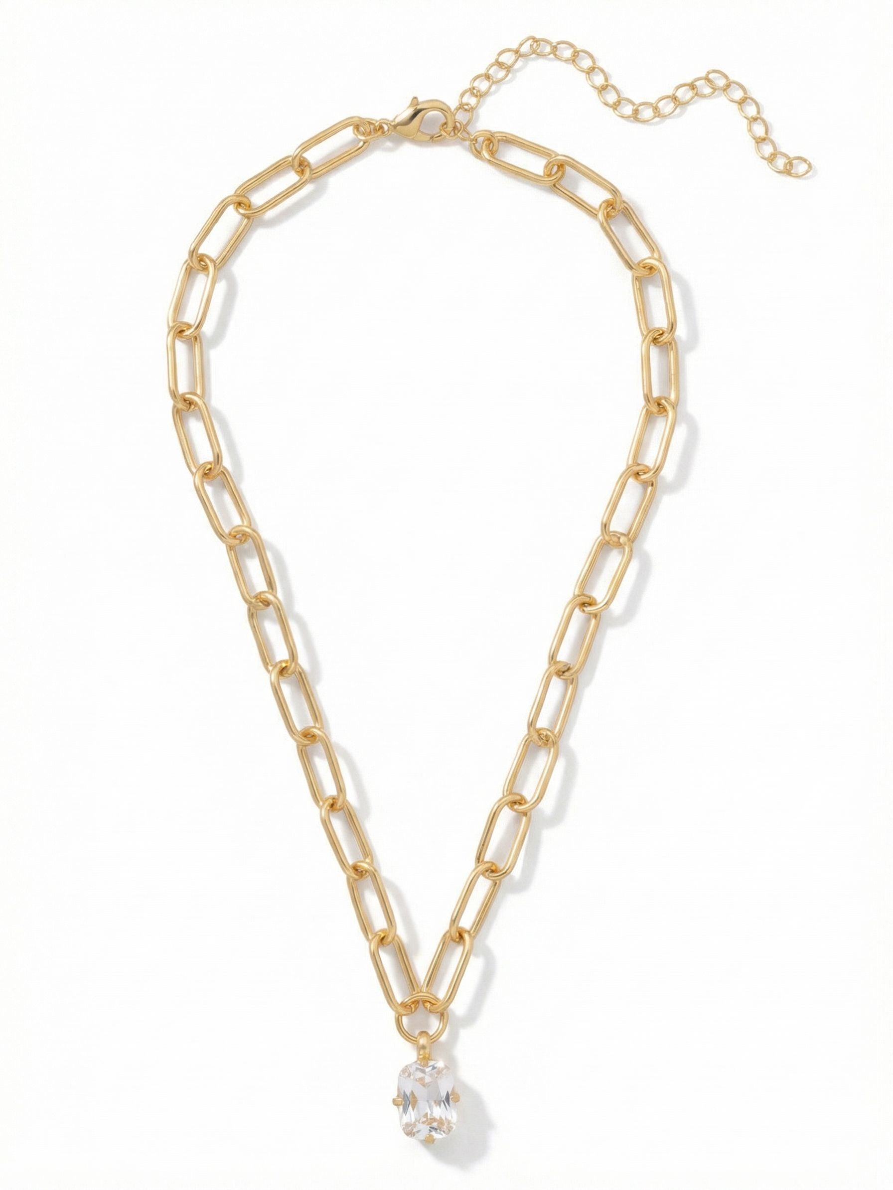 Nia Oval Pendant Necklace - 4NFJ18BGCRY - <p>A single, sharply faceted clear crystal catches the light as you move. Suspended from a modern gold-tone paperclip chain, the pendant adds quiet brilliance right below the collarbone. The elongated chain links provide a textural contrast with the crisp lines of the stone. Built with an extension chain, this piece easily shifts to complement different necklines or finds the exact right placement for layering with your everyday staples.</p><ul>
<li>Elongated paperclip chain links provide modern texture</li>
<li>Single clear crystal offers focused, classic brilliance</li>
<li>Lobster claw clasp</li>
<li>4-inch adjustable extension chain</li>
<li>Protective e-coat finish for lasting wear</li>
<li>Includes signature organza pouch for gifting and travel</li>
</ul>