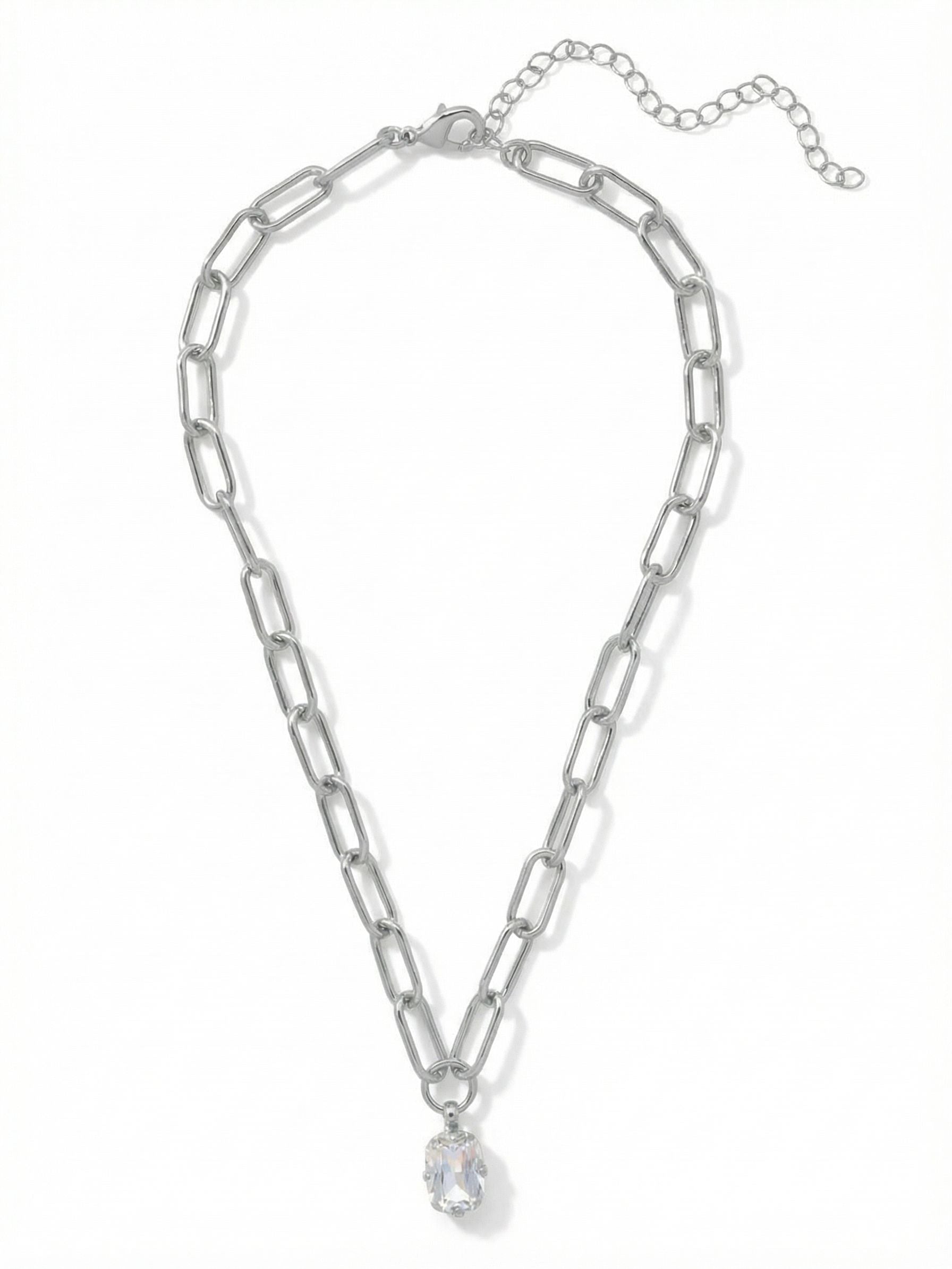 Nia Oval Pendant Necklace - 4NFJ18PDCRY - <p>A single emerald-cut crystal drops from a substantial paperclip chain. The geometric links add a quiet modern edge to the traditional solitaire pendant. It drapes naturally near the collarbone, catching the light as you move through your day. An included extension chain allows you to adjust the drop, making it an easy piece to layer with finer strands or wear alone against a bare neckline.</p><ul>
<li>Modern paperclip chain construction adds geometric texture</li>
<li>A single emerald-cut crystal anchors the piece</li>
<li>Lobster claw clasp</li>
<li>4-inch adjustable extension chain</li>
<li>Protective e-coat finish for lasting wear</li>
<li>Includes signature organza pouch for gifting and travel</li>
</ul>