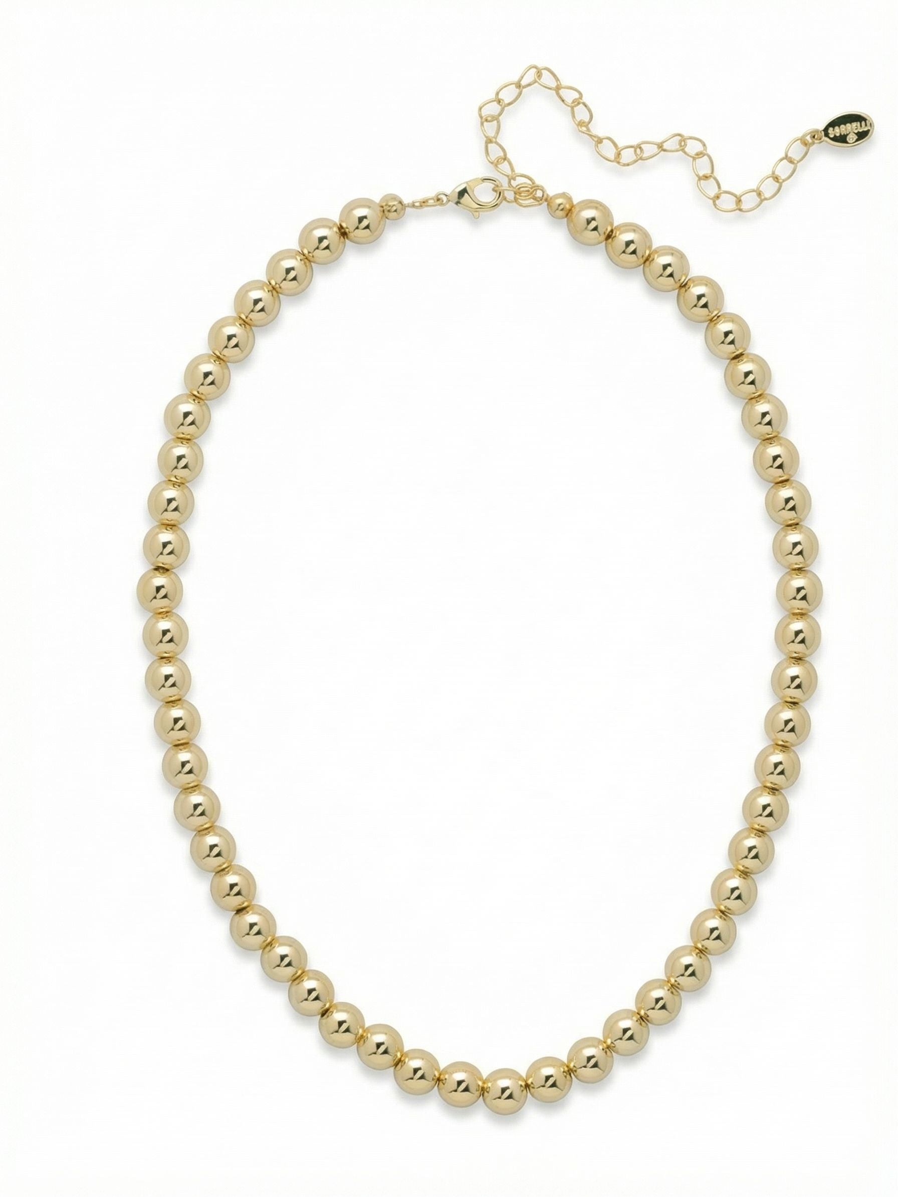 Zola Tennis Necklace - 4NFJ21BGMTL - <p>A continuous line of highly polished metallic spheres replaces traditional crystals in this modern interpretation of the tennis necklace. The smooth rounded beads catch the light with a fluid, mirror-like finish, offering a distinct presence at the collarbone. Built with enough weight to drape naturally and follow your movement, this piece works beautifully as a standalone foundation or layered with delicate chains. The built-in extension chain allows you to easily adjust the length for different necklines.</p><ul>
<li>Continuous strand of high-shine metallic spheres</li>
<li>Fluid articulation allows the piece to drape naturally</li>
<li>Lobster claw clasp</li>
<li>4-inch adjustable extension chain</li>
<li>Protective e-coat finish for lasting wear</li>
<li>Includes signature organza pouch for gifting and travel</li>
</ul>