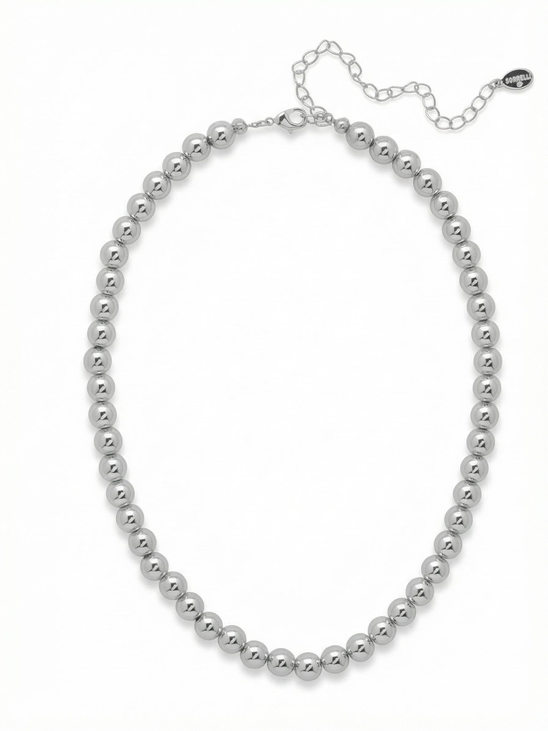 Zola Tennis Necklace - 4NFJ21PDMTL - <p>A continuous line of polished metallic spheres creates a fluid weight that drapes effortlessly along the collarbone. The high-shine palladium finish catches and reflects ambient light, offering a clean, reflective alternative to faceted stones. The rounded beads provide a substantial feel and smooth texture that moves naturally with you. Built with a simple extension chain, the length adjusts to match different necklines, making it a reliable anchor piece for layered chains or a quiet metallic accent on its own.</p><ul>
<li>Continuous line of uniform spherical beads</li>
<li>High-polish metallic finish for a sleek mirror effect</li>
<li>Lobster claw clasp</li>
<li>4-inch adjustable extension chain</li>
<li>Protective e-coat finish for lasting wear</li>
<li>Includes signature organza pouch for gifting and travel</li>
</ul>