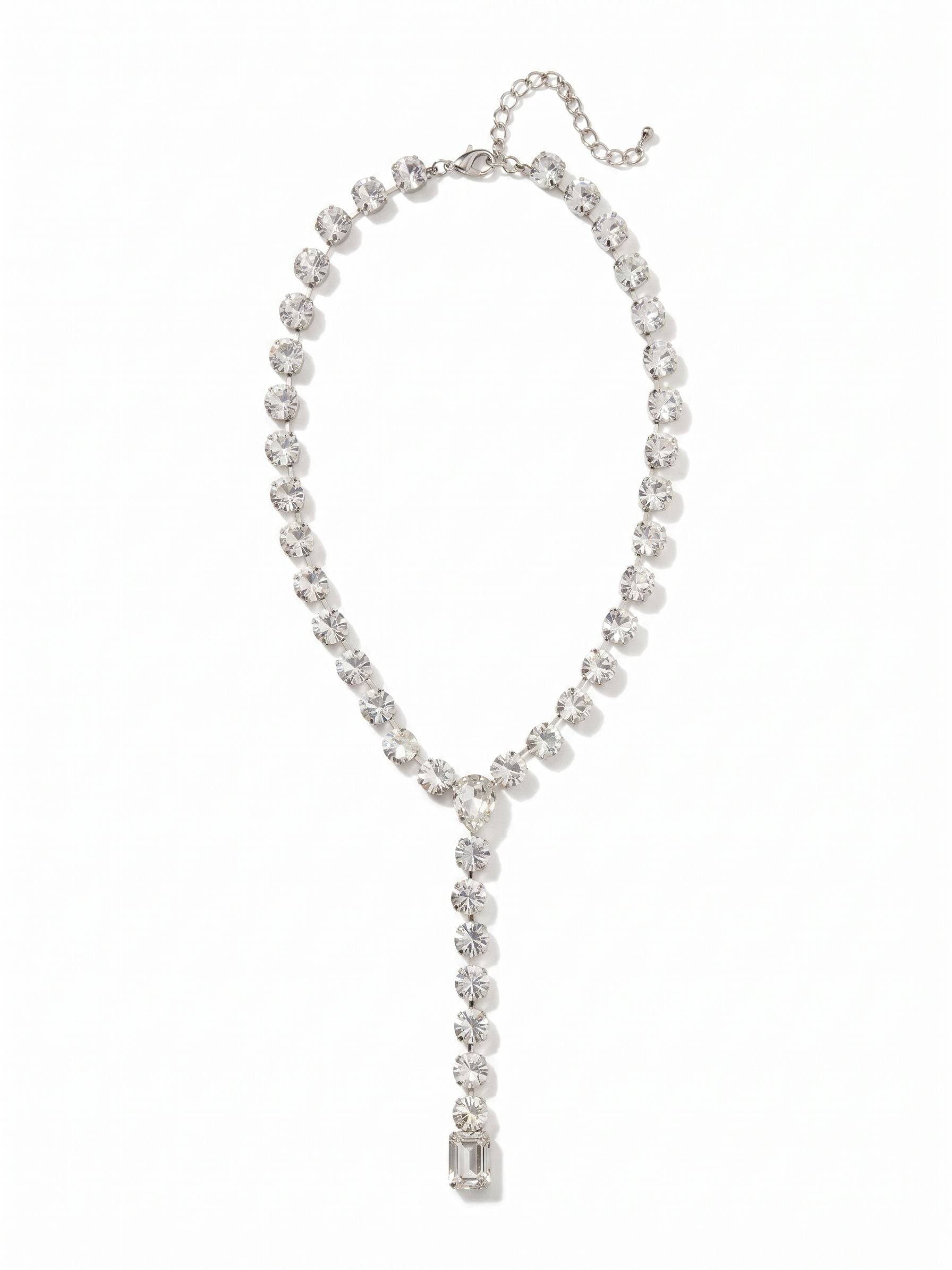 Lucille Lariat Statement Necklace - 4NFL3PDCRY - <p>A continuous line of large round-cut clear crystals drapes along the collarbone to form the foundation of this lariat necklace. The silhouette anchors at a distinct pear-cut stone before plunging into a fluid drop, grounded by a weighty emerald-cut crystal. Built on a flexible kette chain, the design moves with your natural rhythm and captures light continuously. An included extension chain allows you to tailor the plunge directly to your neckline, ensuring the pendant rests exactly where you want it.</p><ul>
<li>Fluid lariat silhouette anchored by a bold pear-cut junction</li>
<li>Linear drop finished with a weighty emerald-cut crystal</li>
<li>Lobster claw clasp</li>
<li>4-inch adjustable extension chain</li>
<li>Protective e-coat finish for lasting wear</li>
<li>Includes signature organza pouch for gifting and travel</li>
</ul>
