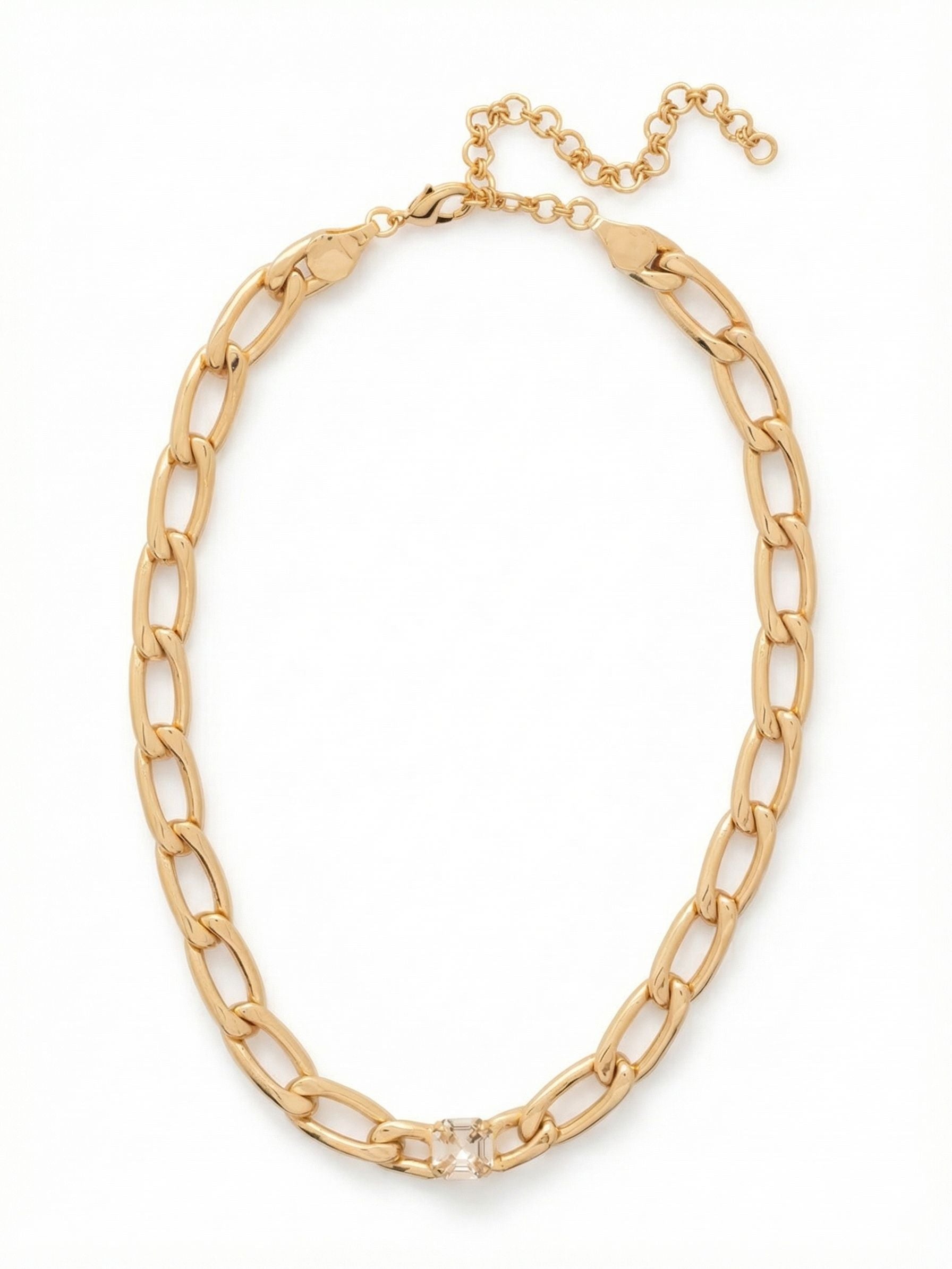 Kirby Single Crystal Tennis Necklace - 4NFP9BGCRY - <p>A single oversized square crystal anchors this substantial curb chain, creating a sharp focal point right at the collarbone. The polished gold-tone links offer a satisfying weight and fluid movement as you go about your day. Designed to drape comfortably at the base of the neck, the extension chain lets you adjust the exact drop to suit your neckline. It easily grounds a layered stack of delicate chains or holds its own worn solo with an open collar.</p><ul>
<li>Oversized square-cut crystal integrated into a chunky curb chain</li>
<li>Substantial elongated links create a bold metallic profile</li>
<li>Lobster claw clasp</li>
<li>4-inch adjustable extension chain</li>
<li>Protective e-coat finish for lasting wear</li>
<li>Includes signature organza pouch for gifting and travel</li>
</ul>