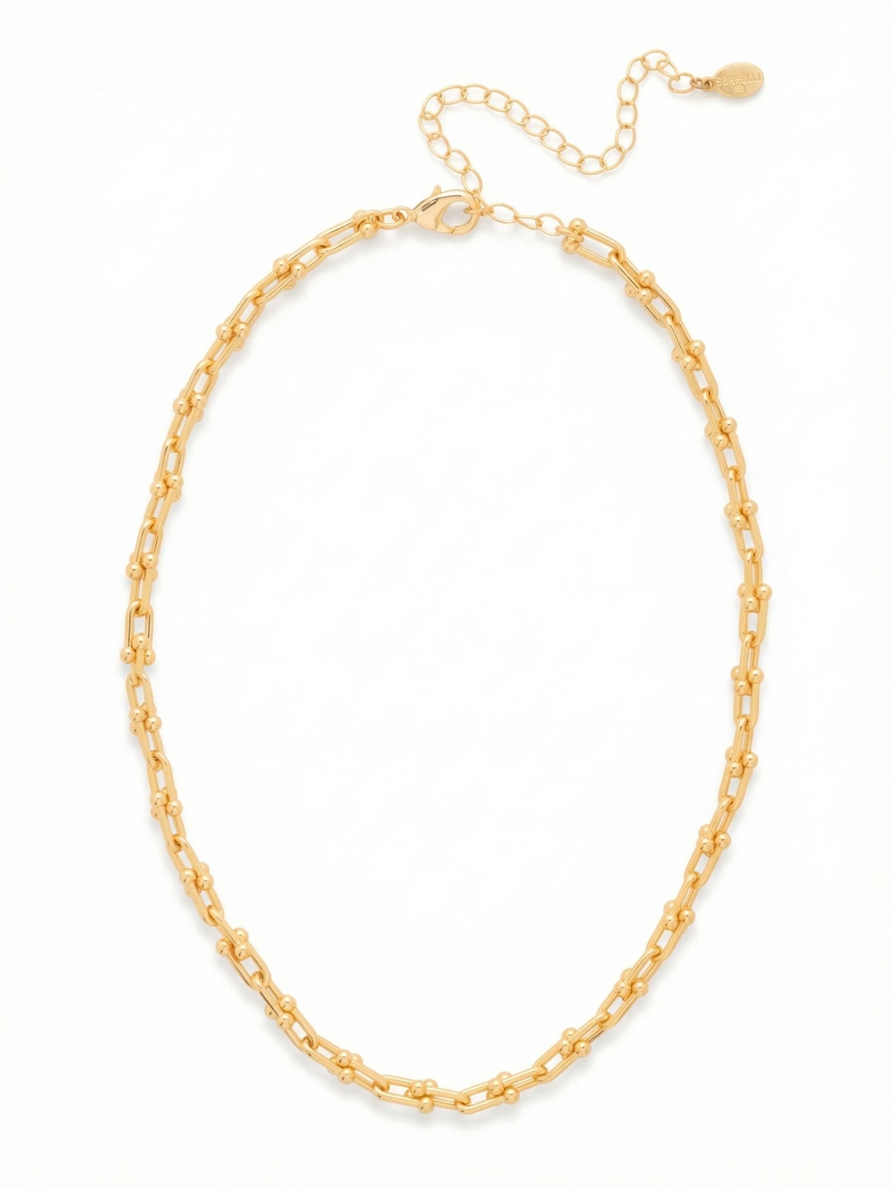 Unity Tennis Necklace - 4NFS8BGMTL - <p>Reimagining the continuous line of a classic tennis silhouette, this necklace relies entirely on solid gold-tone hardware. Elongated open links connect with small metallic spheres, creating a repeating architectural rhythm that settles gracefully at the collarbone. It drapes naturally while maintaining a substantial presence, offering a polished gleam over traditional sparkle. This piece works as a strong base to anchor delicate chains or stands effortlessly alone, with an extension chain to adjust the fit to your neckline.</p><ul>
<li>Elongated hardware links accented with polished metallic spheres</li>
<li>Fluid continuous construction that follows the collarbone naturally</li>
<li>Lobster claw clasp</li>
<li>4-inch adjustable extension chain</li>
<li>Protective e-coat finish for lasting wear</li>
<li>Includes signature organza pouch for gifting and travel</li>
</ul>