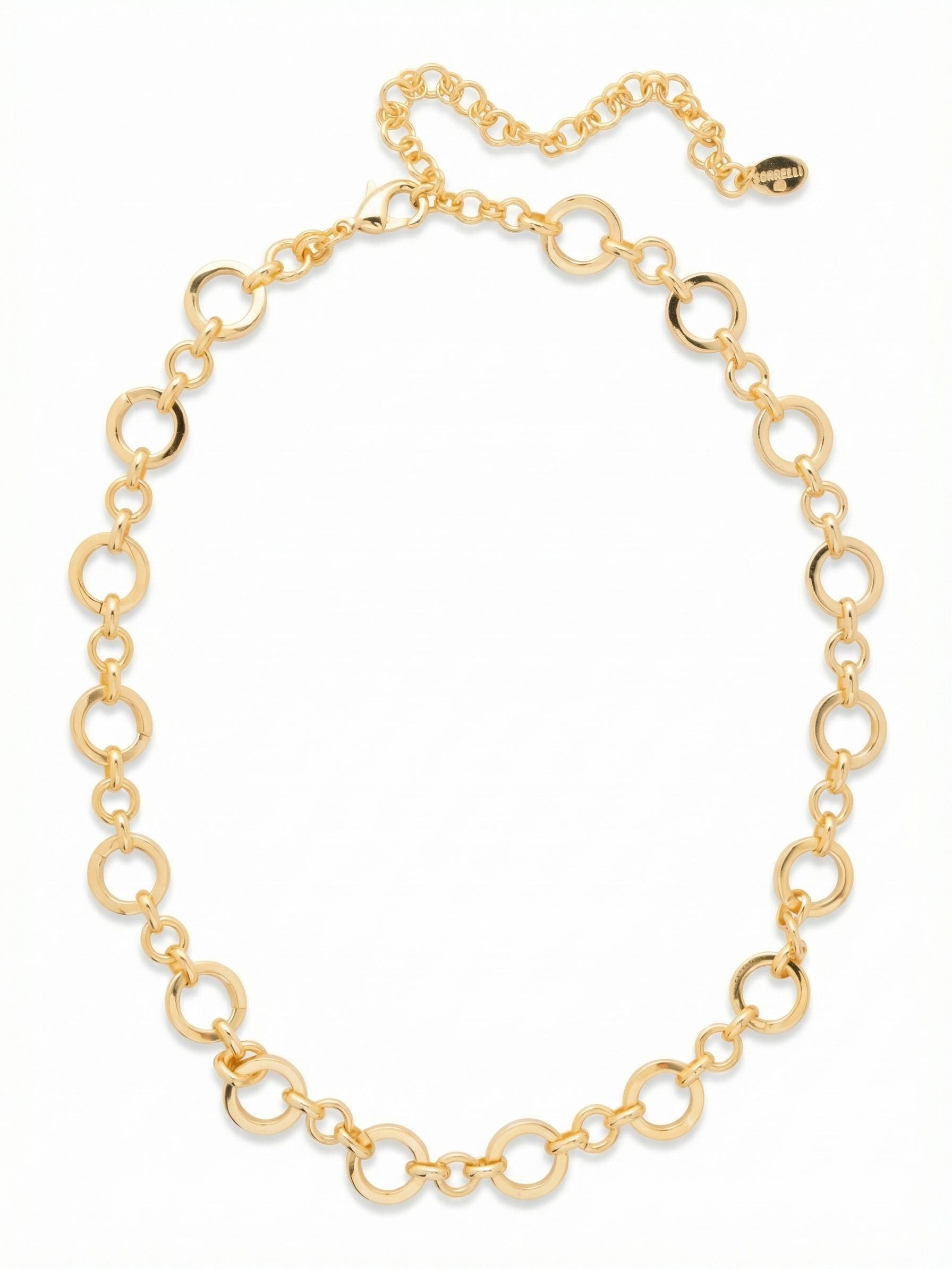 Shirley Tennis Necklace - 4NFZ2BGMTL - <p>A continuous line of alternating circular links creates a fluid drape along the collarbone. The highly polished gold tone catches the light with every movement, offering a bright metallic focal point. The open link design keeps the overall weight light and comfortable for all-day wear. An extension chain allows you to adjust the drop, making it easy to nestle this piece right at the neckline of a crisp white shirt or let it hang loose over a lightweight sweater.</p><ul>
<li>Alternating smooth circular links create a continuous open chain</li>
<li>Highly polished metallic surfaces reflect light from every angle</li>
<li>Lobster claw clasp</li>
<li>4-inch adjustable extension chain</li>
<li>Protective e-coat finish for lasting wear</li>
<li>Includes signature organza pouch for gifting and travel</li>
</ul>
