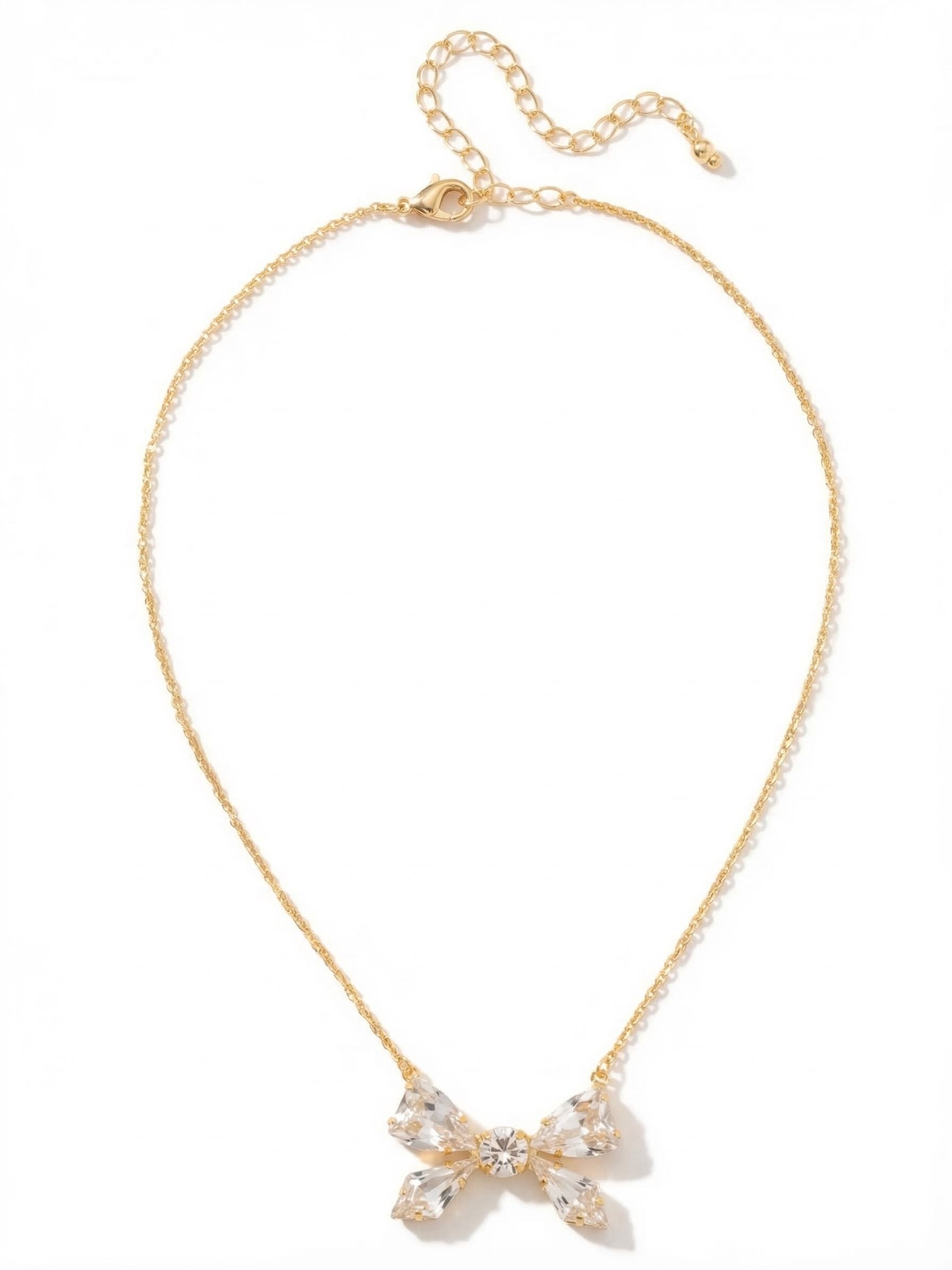Colette Pendant Necklace - 4NFZ5BGCRY - <p>A delicate cable chain anchors a distinctly modern take on a classic silhouette. Rather than relying on sculpted metal, this pendant shapes its bow design entirely through the precise arrangement of clear crystals. Four tapered stones form the loops and tails, gathered cleanly around a faceted round-cut center. It rests gently near the collarbone, catching ambient light with every slight shift in your posture. An extension chain allows you to tailor the drop to match your specific neckline.</p><ul>
<li>Bow motif constructed entirely from precisely angled clear crystals</li>
<li>Fine cable chain allows the crystal pendant to remain the central focus</li>
<li>Lobster claw clasp</li>
<li>4-inch adjustable extension chain</li>
<li>Protective e-coat finish for lasting wear</li>
<li>Includes signature organza pouch for gifting and travel</li>
</ul>
