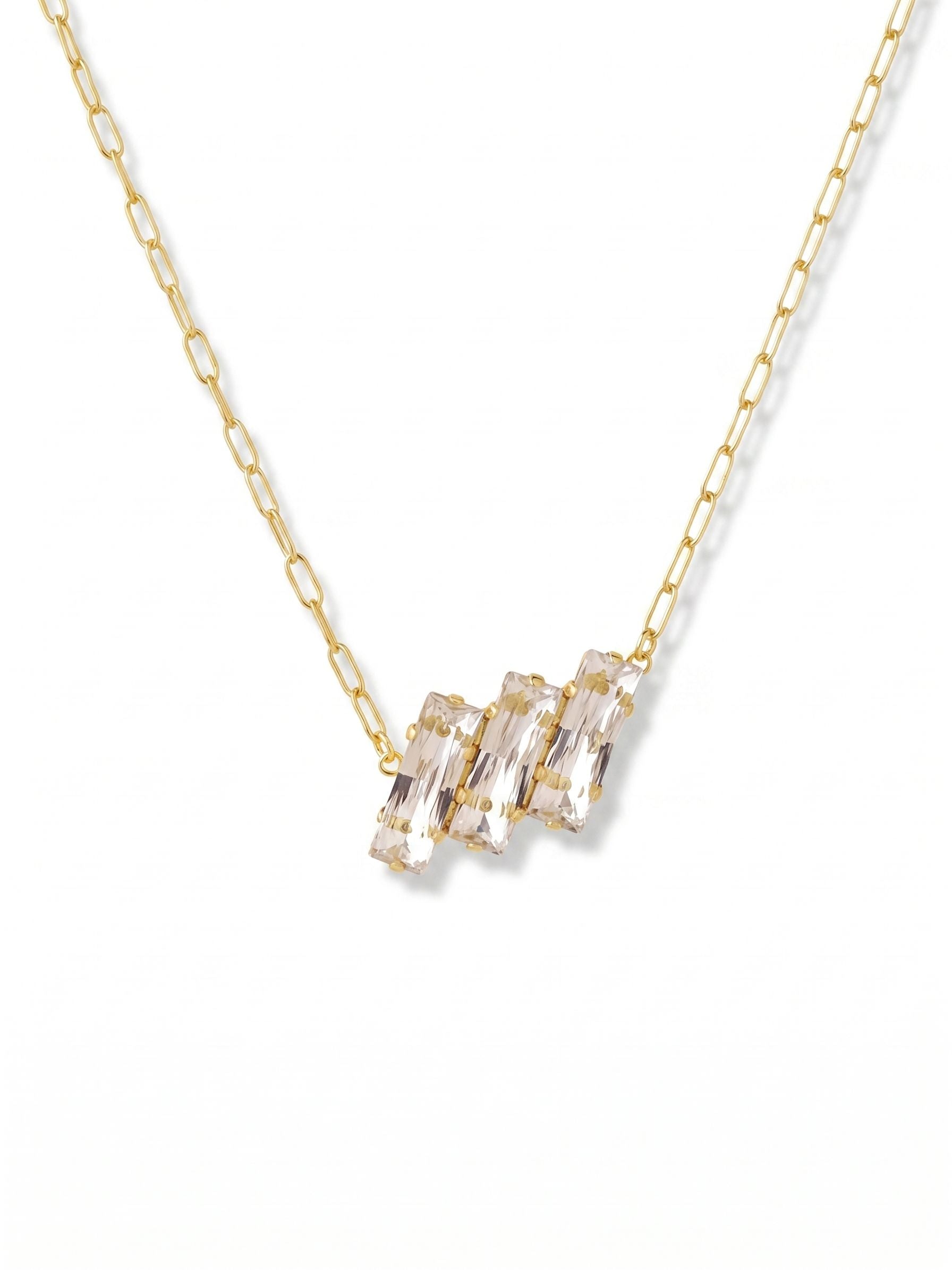 Brayden Pendant Necklace - 4NGK8BGCRY - <p>Three crisp baguette crystals form a clean architectural line at the collarbone. The bright gold tone setting frames the step-cut stones, catching light with a sharp, linear flash rather than a scattered sparkle. It brings a grounded geometry to soft knits or an open collar. An included extension chain lets you adjust the drop perfectly for your neckline. This is a quiet, considered signature piece that works effortlessly into your daily rotation.</p><ul>
<li>Sleek architectural grouping of step-cut baguette crystals</li>
<li>Clean geometric profile that delivers sharp linear light</li>
<li>Lobster claw clasp</li>
<li>4-inch adjustable extension chain</li>
<li>Protective e-coat finish for lasting wear</li>
<li>Includes signature organza pouch for gifting and travel</li>
</ul>