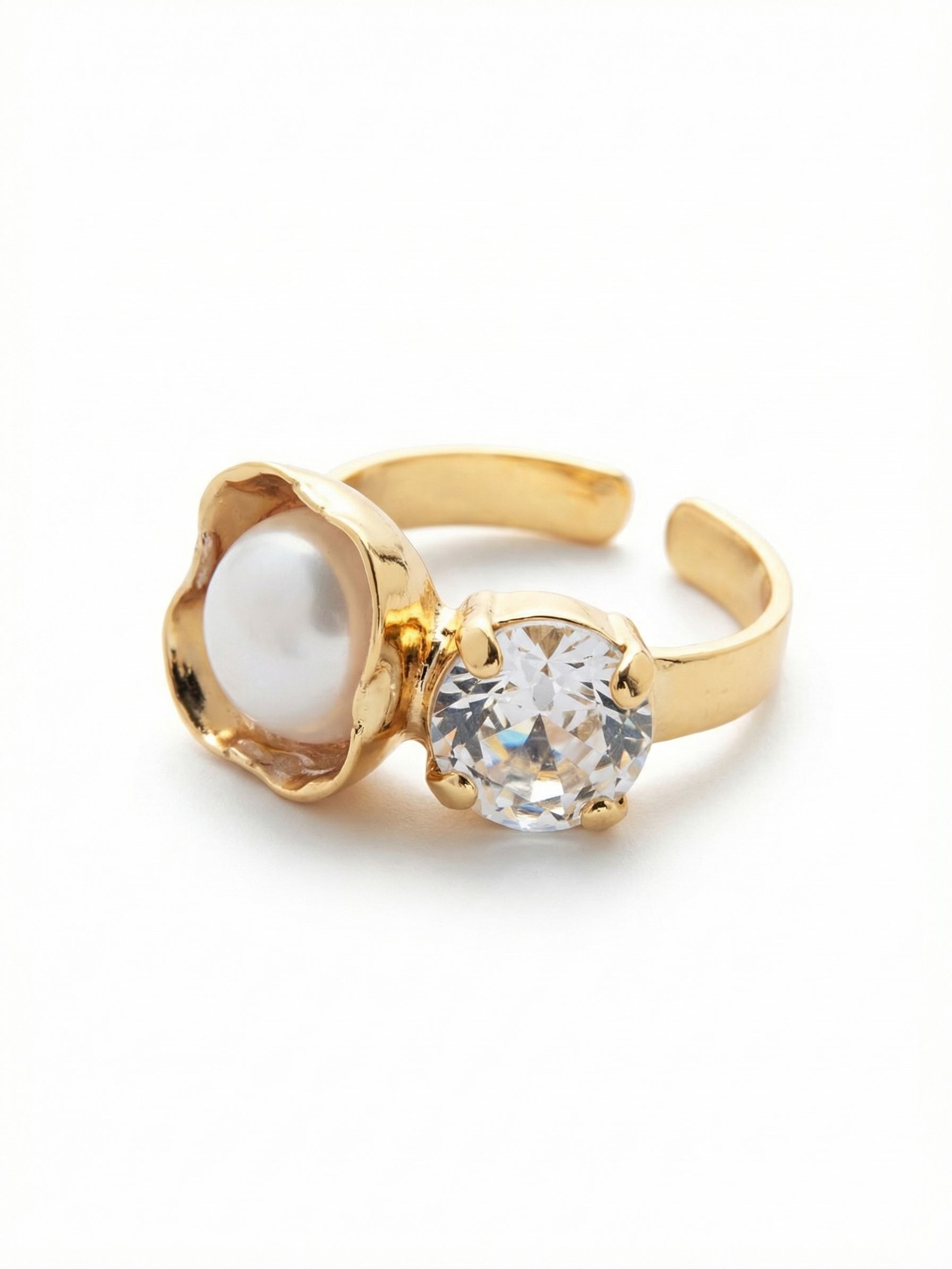 Kaylee Cocktail Ring - 4REV8BGMDP - <p>The Kaylee cocktail ring pairs two classic elements with an artisan twist. A smooth white pearl rests inside an organically textured gold cup, sitting right beside the sharp, light-catching facets of a round clear crystal. This deliberate contrast creates a striking focal point on the hand. The open band design allows you to easily adjust the fit, accommodating changes in temperature or allowing you to comfortably swap the ring between fingers.</p><ul>
<li>Organically waved metal setting cradles the smooth white pearl</li>
<li>High-contrast pairing of a soft pearl alongside a sharply faceted clear crystal</li>
<li>Adjustable ring band</li>
<li>Protective e-coat finish for lasting wear</li>
<li>Includes signature organza pouch for gifting and travel</li>
</ul>