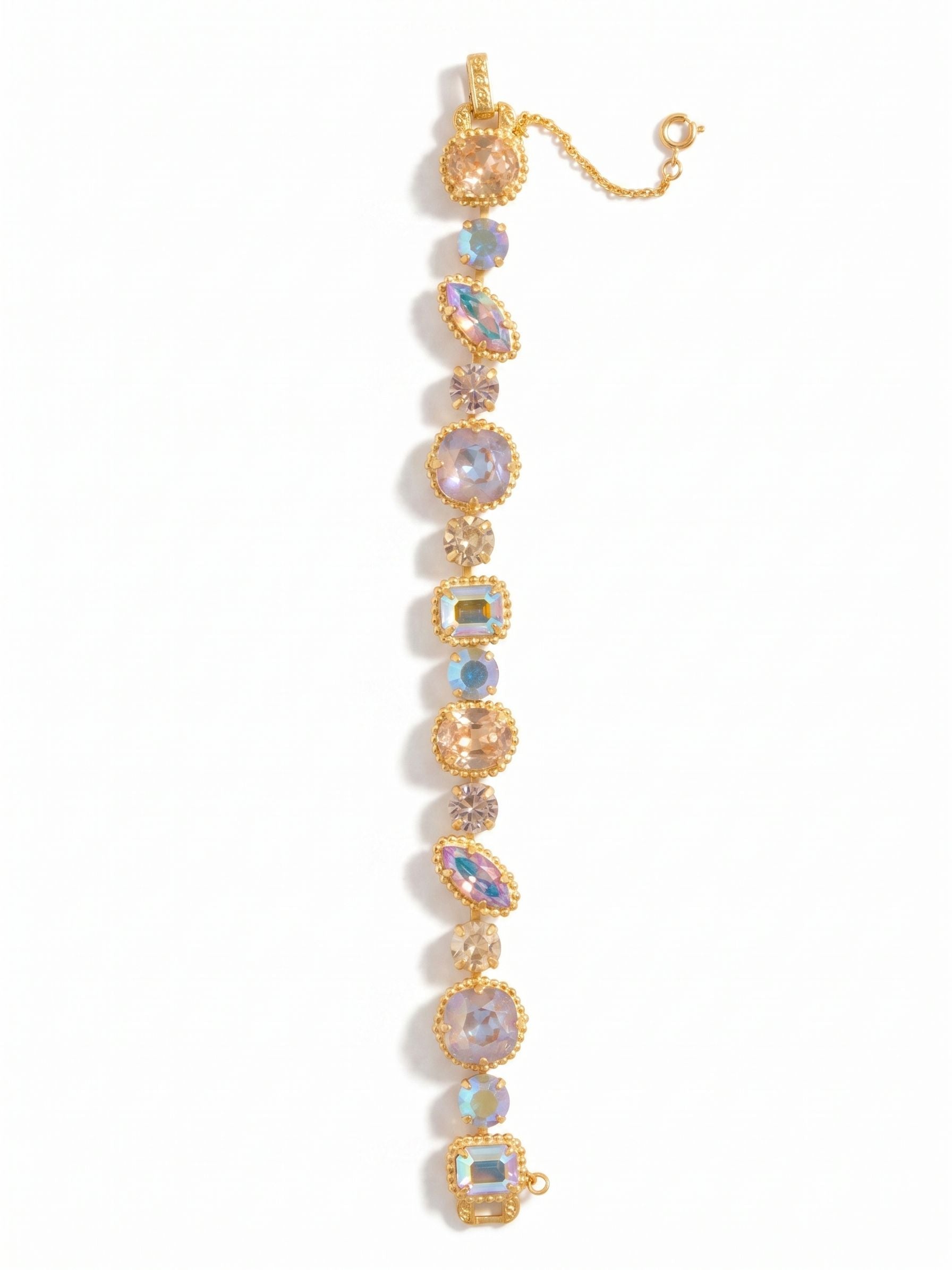 Cushion-Cut Tennis Bracelet - BBX100BGCHA - <p>A continuous line of shifting geometry brings a complex rhythm to your daily rotation. This tennis bracelet pairs soft blush ovals and warm golden cushions with sharp iridescent emerald cuts, creating a highly textured sequence of light. The varied shapes are tightly framed in distinct settings that articulate fluidly as your wrist moves. A delicate safety chain anchors the spring ring clasp, keeping the piece secure during busy days. Its substantial weight provides a grounded, confident presence from morning to evening.</p><ul>
<li>A complex sequence of mixed crystal cuts</li>
<li>Fluidly articulated settings that move with your wrist</li>
<li>Protective e-coat finish for lasting wear</li>
<li>Includes signature organza pouch for gifting and travel</li>
</ul>