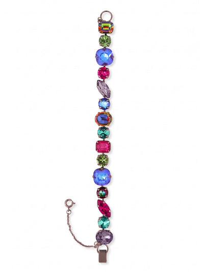 Teddy Tennis Bracelet - BBX101GMNNI - <p>Deep jewel tones and shifting hues define this substantial piece, drawing from the dark celestial palette of deep space. Instead of uniform settings, a structured sequence of cushion, marquise, and emerald-cut crystals creates an unpredictable rhythm of light as your hand moves. The carefully linked channel construction allows the heavier stones to move fluidly with your natural gestures. A secure fold-over clasp and fine safety chain ensure this weighty bracelet stays exactly where you place it, offering an assertive anchor for a considered daily rotation.</p><ul>
<li>Unpredictable sequence of mixed crystal cuts including oval, marquise, and emerald shapes</li>
<li>Articulated channel chain construction allows substantial stones to move naturally</li>
<li>Fold-over clasp with secure safety chain</li>
<li>Includes signature organza pouch for gifting and travel</li>
</ul>