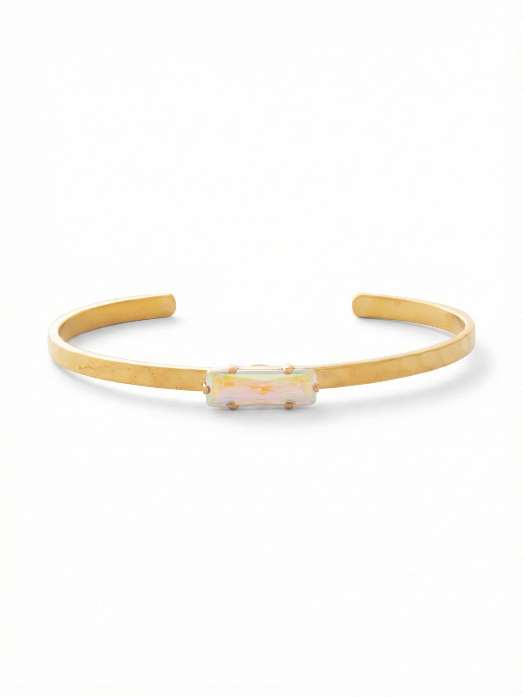 Bindi Cuff Bracelet - BCW13BGCAB - <p>A clean line of bright metal anchors a solitary baguette crystal that cycles through soft iridescent hues as your wrist moves. The open cuff design slips on in an instant, holding its shape with quiet certainty. Barely a quarter-inch wide, it brings an architectural edge to a curated bracelet stack while carrying enough visual weight to anchor a bare arm beautifully on its own.</p><ul>
<li>Solitary horizontally set baguette crystal</li>
<li>Minimalist architectural metal band designed for easy stacking</li>
<li>Adjustable open cuff slides on easily</li>
<li>Protective e-coat finish for lasting wear</li>
<li>Includes signature organza pouch for gifting and travel</li>
</ul>