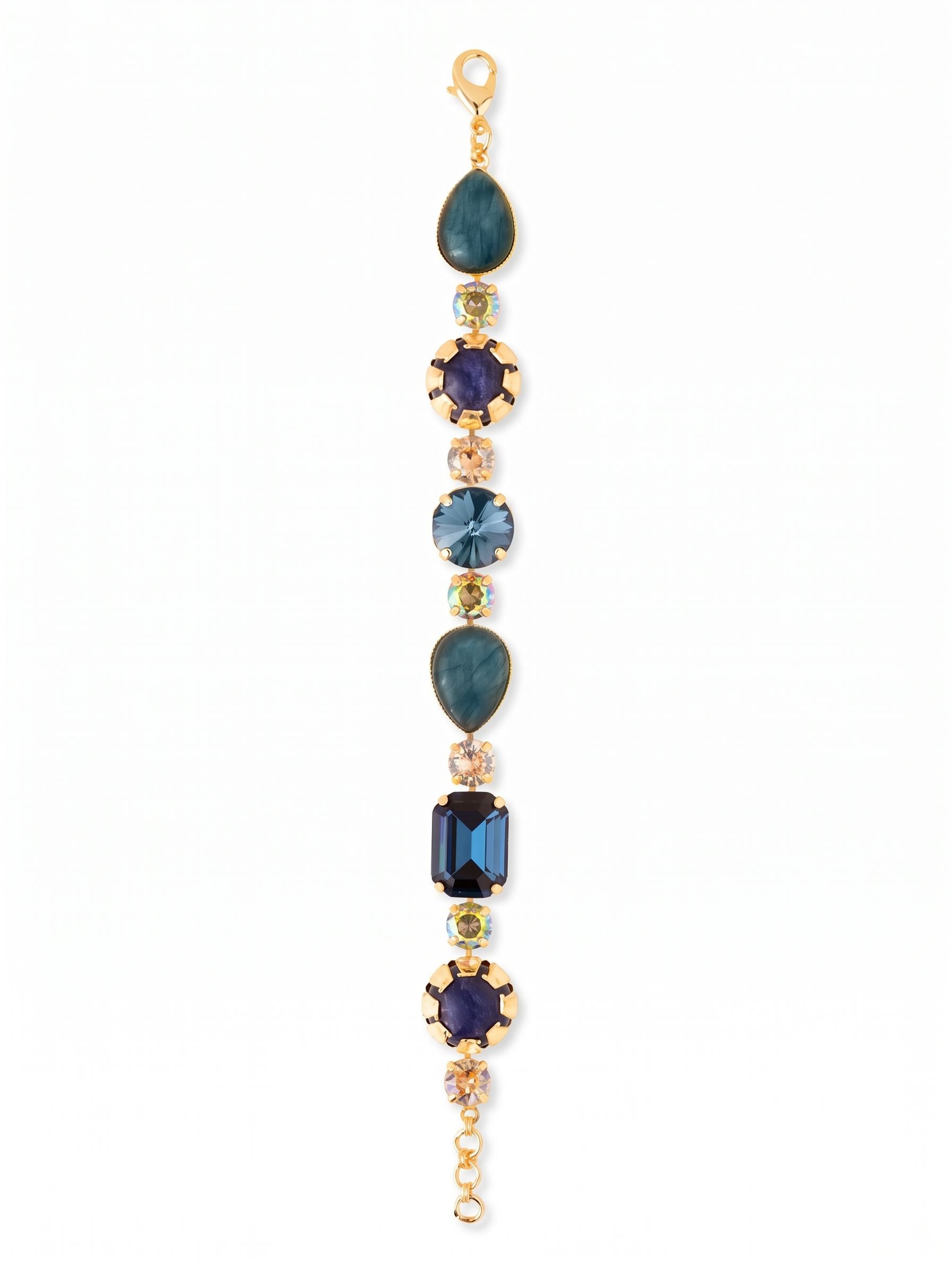 Tatiana Tennis Bracelet - BEP57BGDNM - <p>Deep blue sodalite and pear-cut labradorite alternate with flashes of golden shadow crystals to create a textured, rhythmic line. Centered by an emerald-cut Light Montana stone, this tennis bracelet balances opaque materials with highly faceted glass for a complex play of light. The articulated chain construction allows the piece to drape organically and move fluidly with your hand. It brings a grounded earthy palette to a classic silhouette. An extension chain lets you tailor the length so it feels secure throughout the day.</p><ul>
<li>Mixes opaque stones with faceted crystals for textural contrast</li>
<li>Articulated chain construction allows fluid movement along the arm</li>
<li>Lobster claw clasp</li>
<li>3/4-inch adjustable extension chain</li>
<li>Protective e-coat finish for lasting wear</li>
<li>Includes signature organza pouch for gifting and travel</li>
</ul>