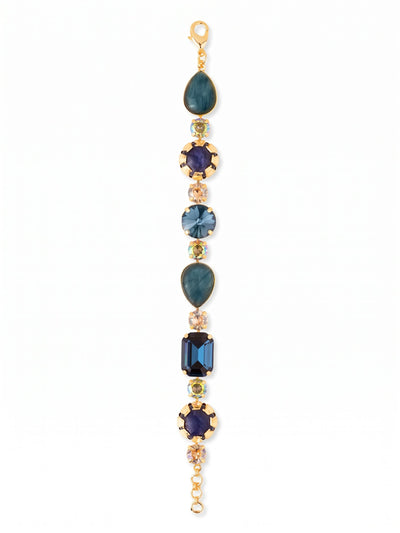 Tatiana Tennis Bracelet - BEP57BGDNM - <p>Deep blue sodalite and pear-cut labradorite alternate with flashes of golden shadow crystals to create a textured, rhythmic line. Centered by an emerald-cut Light Montana stone, this tennis bracelet balances opaque materials with highly faceted glass for a complex play of light. The articulated chain construction allows the piece to drape organically and move fluidly with your hand. It brings a grounded earthy palette to a classic silhouette. An extension chain lets you tailor the length so it feels secure throughout the day.</p><ul>
<li>Mixes opaque stones with faceted crystals for textural contrast</li>
<li>Articulated chain construction allows fluid movement along the arm</li>
<li>Lobster claw clasp</li>
<li>3/4-inch adjustable extension chain</li>
<li>Protective e-coat finish for lasting wear</li>
<li>Includes signature organza pouch for gifting and travel</li>
</ul>
