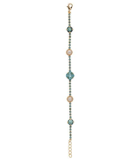Caterina Tennis Bracelet - BES11BGAQU - <p>The Caterina Tennis Bracelet is a stylishly symmetrical piece, dotted with fashionable freshwater pearls and an iredescent crystal at its center. From Sorrelli's Aquamarine collection in our Bright Gold-tone finish.</p>