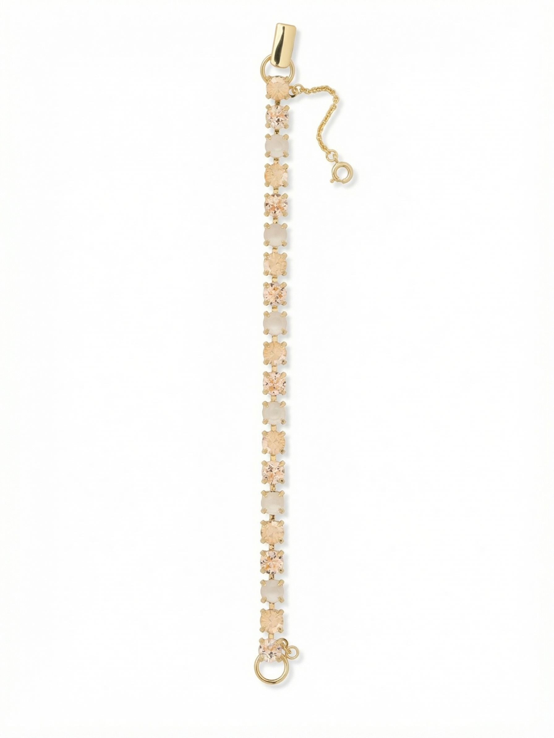 Elsie Tennis Bracelet - BEZ30BGGGO - <p>This tennis bracelet brings a steady ribbon of warm, sunlit color to your daily rotation. Round crystals in soft silk, golden shadow, and iridescent white alternate along a substantial cable chain, catching the light beautifully as your hands move. The fold-over clasp includes a dedicated safety chain, giving you complete confidence when you wear it through busy afternoons or quiet evenings out. It brings a refined, golden goddess warmth to your existing stack without overwhelming your other favorite pieces.</p><ul>
<li>Continuous line of alternating round crystals in warm neutral shades</li>
<li>Set on a substantial cable chain for fluid daily movement</li>
<li>Fold-over clasp with secure safety chain</li>
<li>Protective e-coat finish for lasting wear</li>
<li>Includes signature organza pouch for gifting and travel</li>
</ul>