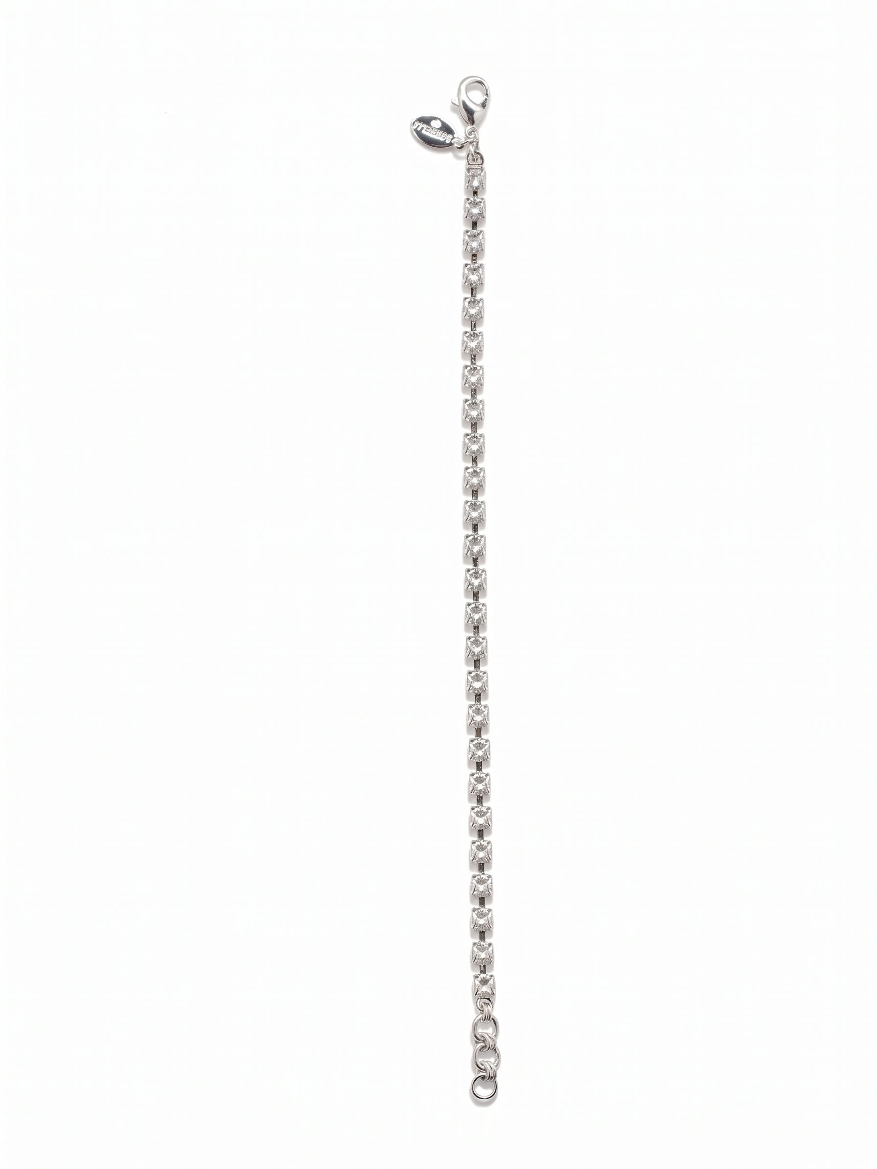 Marnie Tennis Bracelet - BFA2PDCRY - <p>A definitive take on an absolute essential. This slender tennis bracelet creates an unbroken line of clear crystal that catches the light with every gesture. The articulated rhinestone chain flexes beautifully, moving fluidly with your arm rather than feeling stiff or restrictive. An adjustable extension chain lets you find the exact right fit, allowing the piece to work just as well as a solo signature or layered seamlessly into a daily stack.</p><ul>
<li>Slender single-strand profile ideal for daily layering</li>
<li>Articulated chain construction designed for fluid movement</li>
<li>Lobster claw clasp</li>
<li>3/4-inch adjustable extension chain</li>
<li>Protective e-coat finish for lasting wear</li>
<li>Includes signature organza pouch for gifting and travel</li>
</ul>