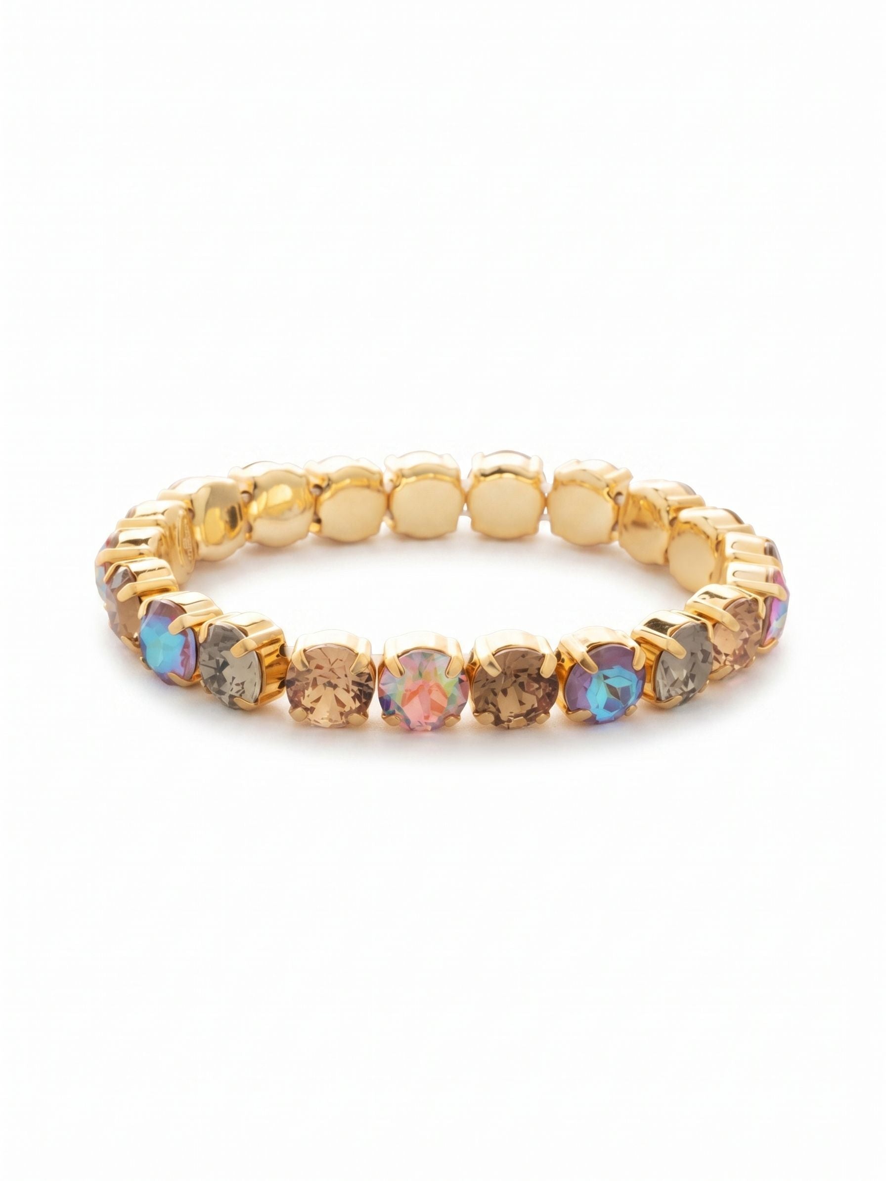 7 inch Sienna Stretch Bracelet - BFD50BGHNB - <p>Rich tones of smoked topaz and cappuccino blend with subtle black diamond to create a grounded, warm palette. Touches of aurora borealis catch the light naturally as your arm moves. The stretch design eliminates the need for clasps, allowing you to slide it easily over your hand. A continuous circle of round-cut crystals delivers substantial weight without feeling restrictive. It becomes an effortless addition to a growing stack or a quiet focal point worn solo.</p><ul>
<li>Alternating warm neutral and iridescent round-cut crystals</li>
<li>Flexible stretch band for effortless single-handed wear</li>
<li>Stretch easy slip-on design</li>
<li>Protective e-coat finish for lasting wear</li>
<li>Includes signature organza pouch for gifting and travel</li>
</ul>