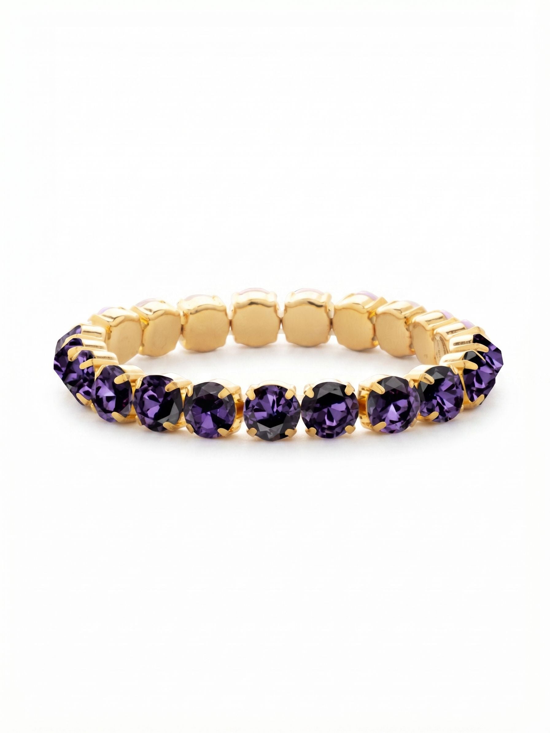 7 inch Sienna Stretch Bracelet - BFD50BGPV - <p>An unbroken circle of saturated color that slips on effortlessly. Deep purple round-cut crystals are framed in warm gold, creating a rich contrast that shifts in the light with every movement of your hand. The stretch construction means no fumbling with clasps, expanding comfortably and settling securely into your daily stack. It holds its own as a single line of intense color, or layers easily alongside heavier cuffs to bring depth to your collection.</p><ul>
<li>Continuous loop of uniform round crystals provides color from every angle</li>
<li>Flexible construction allows for easy slip-on wear without a clasp</li>
<li>Stretch easy slip-on design</li>
<li>Protective e-coat finish for lasting wear</li>
<li>Includes signature organza pouch for gifting and travel</li>
</ul>