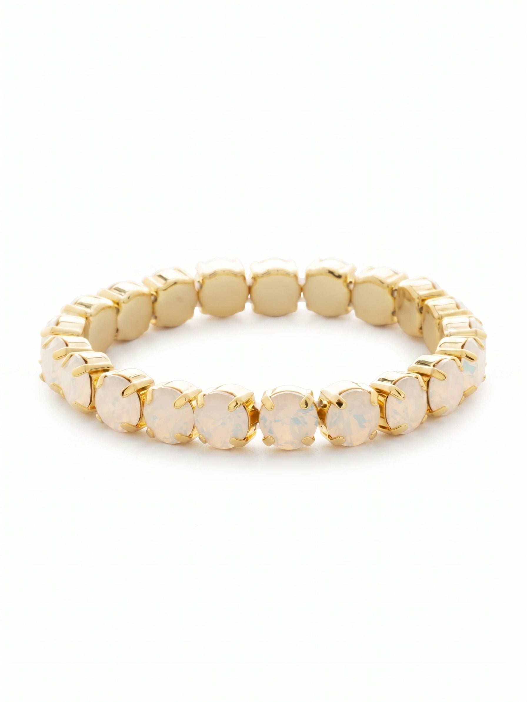 7 inch Sienna Stretch Bracelet - BFD50BGWO - <p>A continuous line of warm, milky white opals set in bright gold. The flexible stretch design slides on effortlessly, bypassing tricky clasps for an immediate, comfortable fit. Each round-cut crystal brings a quiet, luminous glow that plays well with a structured watch or layered cuffs. It feels substantial enough to anchor a stack but soft enough to stand gracefully on its own.</p><ul>
<li>Continuous band of round-cut milky white opals</li>
<li>Flexible stretch construction for an effortless fit</li>
<li>Stretch easy slip-on design</li>
<li>Protective e-coat finish for lasting wear</li>
<li>Includes signature organza pouch for gifting and travel</li>
</ul>