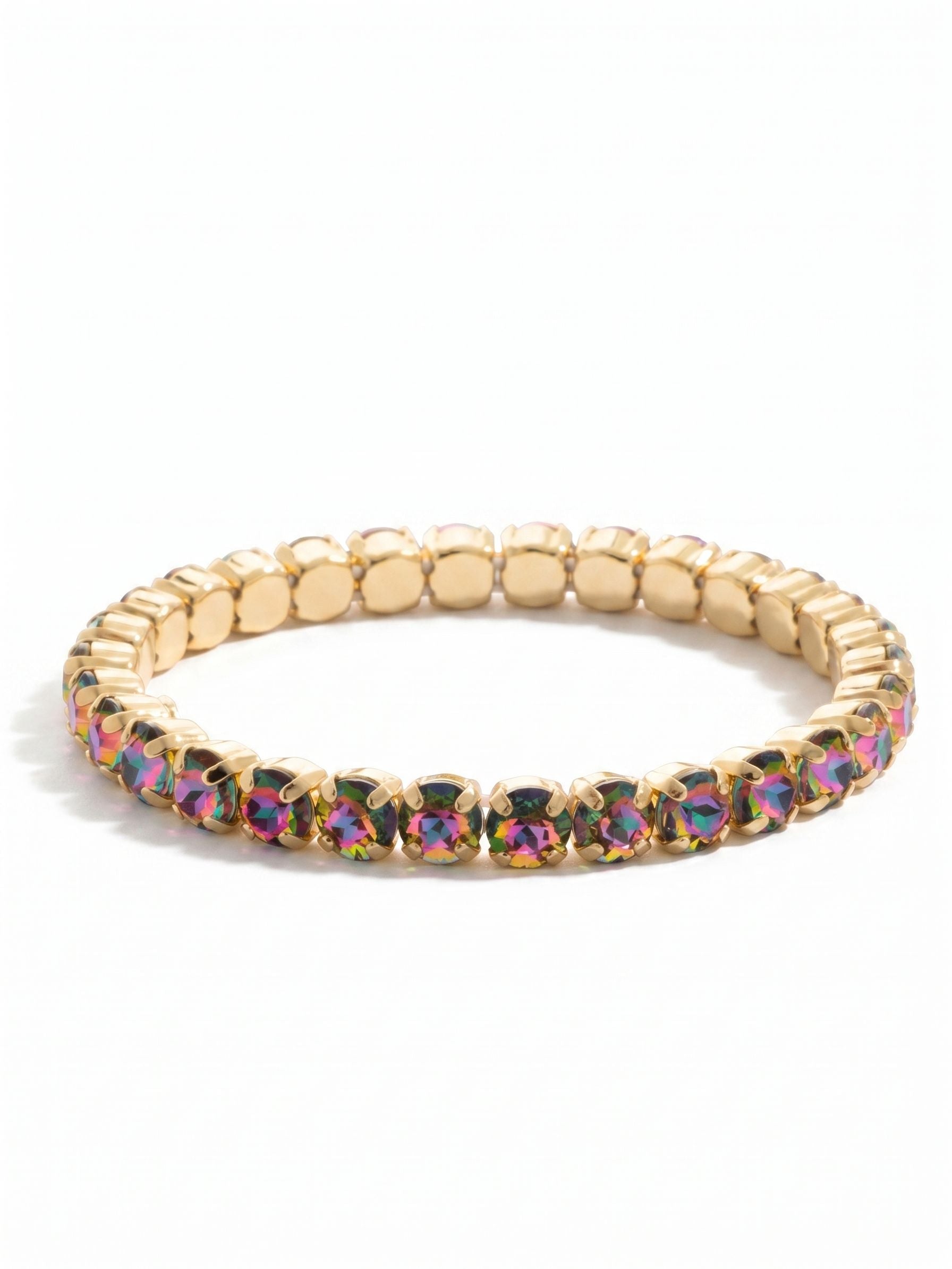 Mini Sienna Stretch Bracelet - BFD52BGVO - <p>A continuous line of shifting color, this stretch bracelet rolls effortlessly over the hand. The round-cut crystals cast vibrant flashes of magenta, deep violet, and green framed by bright gold-tone settings. The flexible construction eliminates the need to fumble with clasps, adapting comfortably to your wrist as you move. It serves as a vivid singular focal point or an easy starting point for building a layered stack.</p><ul>
<li>Continuous loop of color-shifting round-cut crystals</li>
<li>Flexible stretch design rolls easily over the hand</li>
<li>Stretch easy slip-on design</li>
<li>Protective e-coat finish for lasting wear</li>
<li>Includes signature organza pouch for gifting and travel</li>
</ul>