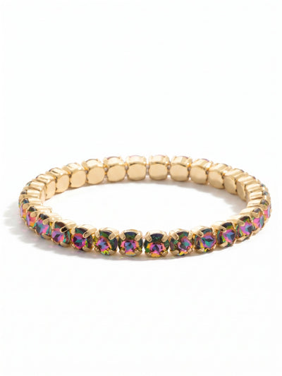 Mini Sienna Stretch Bracelet - BFD52BGVO - <p>A continuous line of shifting color, this stretch bracelet rolls effortlessly over the hand. The round-cut crystals cast vibrant flashes of magenta, deep violet, and green framed by bright gold-tone settings. The flexible construction eliminates the need to fumble with clasps, adapting comfortably to your wrist as you move. It serves as a vivid singular focal point or an easy starting point for building a layered stack.</p><ul>
<li>Continuous loop of color-shifting round-cut crystals</li>
<li>Flexible stretch design rolls easily over the hand</li>
<li>Stretch easy slip-on design</li>
<li>Protective e-coat finish for lasting wear</li>
<li>Includes signature organza pouch for gifting and travel</li>
</ul>
