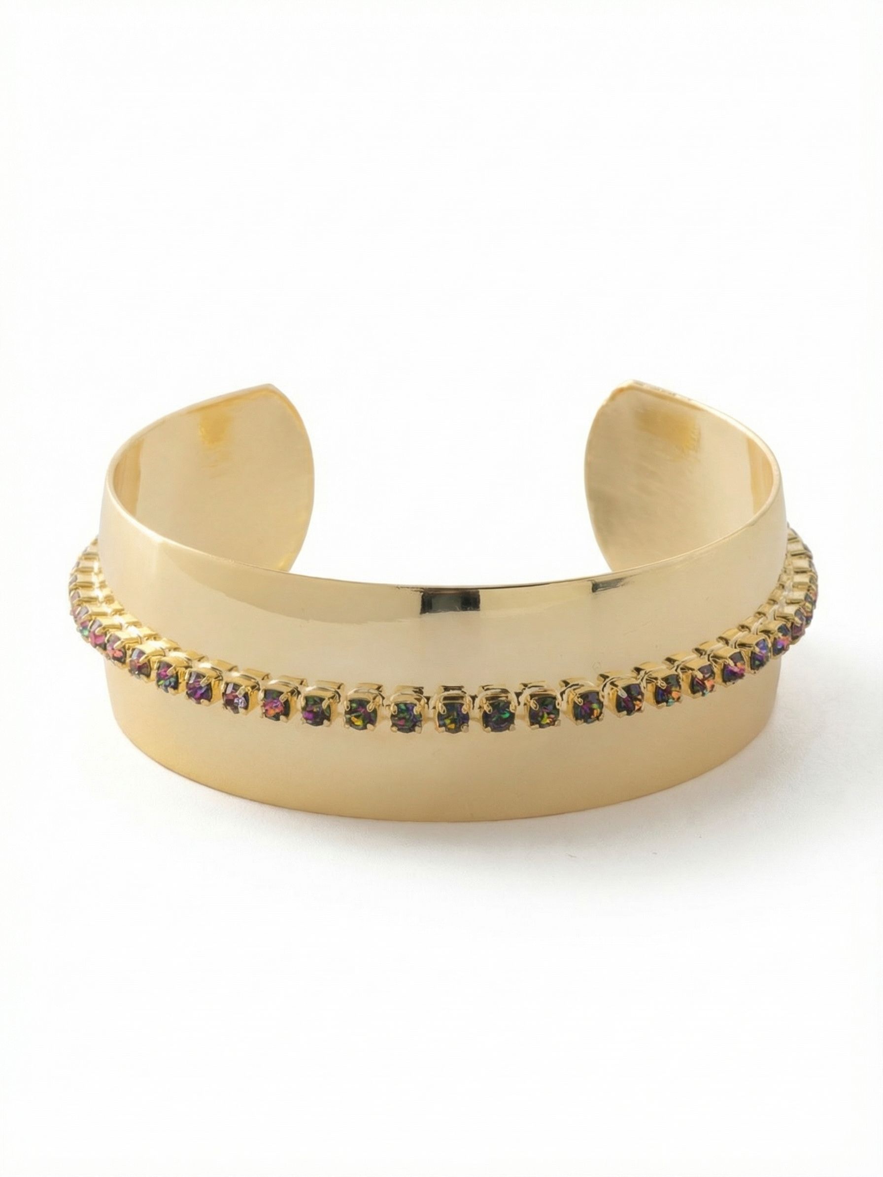 Embellished Cuff Bracelet - BFK3BGVO - <p>A wide expanse of polished metal forms a clean architectural shape on the arm. Bisecting the smooth surface is a single continuous channel of iridescent, dark-toned crystals, creating a sharp contrast between high-shine gold-tone and textured light. The open design slips on effortlessly, offering a substantial look without feeling heavy or restrictive. Worn solo, it anchors a bare wrist, and the streamlined silhouette allows it to slide easily under the sleeve of a tailored blazer.</p><ul>
<li>High-polish metal profile bisected by a continuous crystal channel</li>
<li>Sharp visual contrast between smooth geometric metal and faceted stones</li>
<li>Adjustable open cuff slides on easily</li>
<li>Protective e-coat finish for lasting wear</li>
<li>Includes signature organza pouch for gifting and travel</li>
</ul>