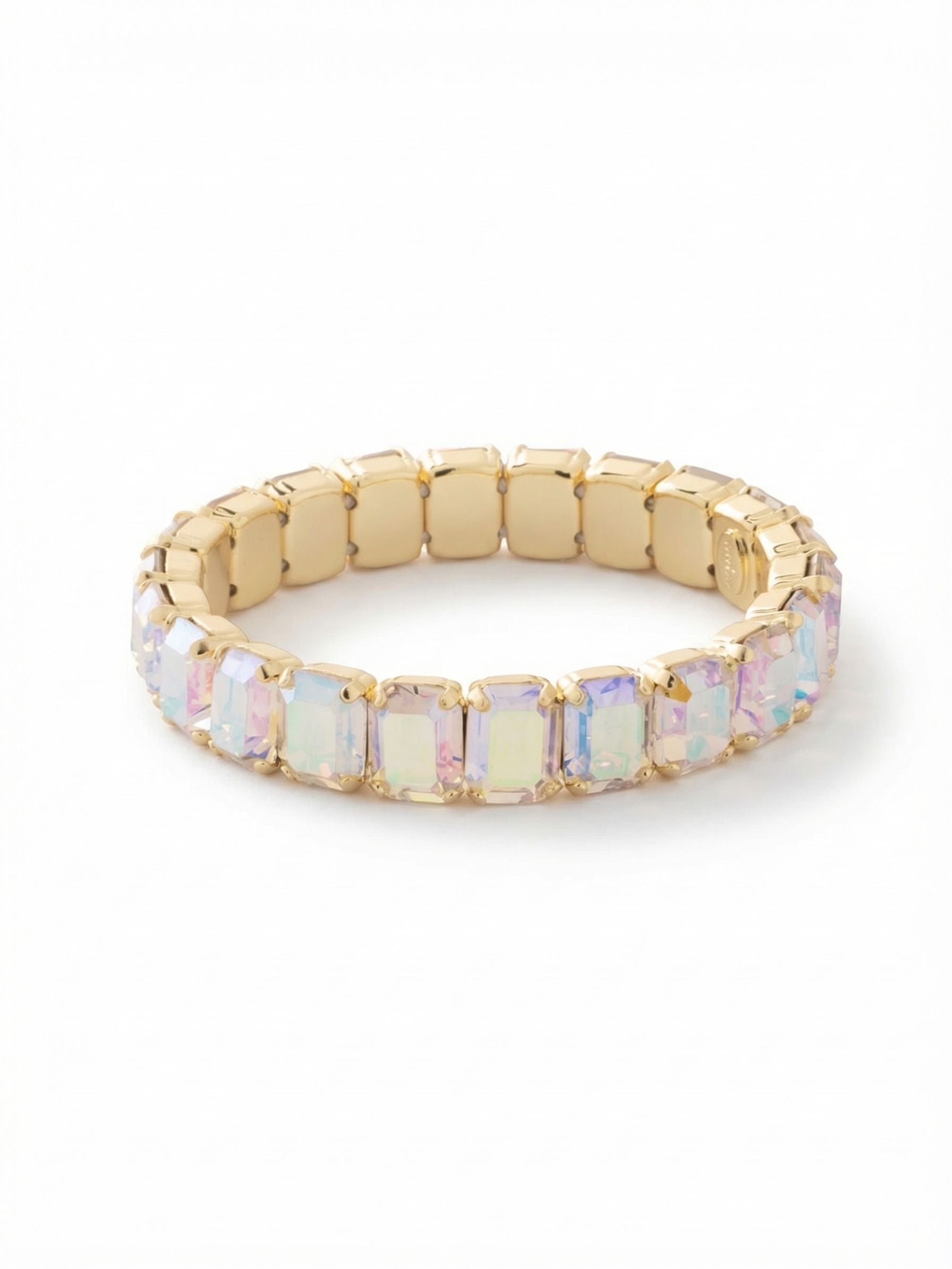 7 inch Octavia Stretch Bracelet - BFM30BGCAB - <p>A continuous loop of architectural emerald cuts brings substantial structure to your everyday jewelry rotation. Because it stretches, you can slip it right over your hand without fussing with a clasp. The hidden elastic core adapts to your natural movement, keeping the rectangular crystals comfortably aligned. Caught in the light, the iridescent facets flash with subtle shifts of color framed by warm gold tones. It holds its own worn solo, or anchors a stack of mixed textures when you want more weight and light at the cuff.</p><ul>
<li>Architectural emerald cuts create a clean continuous line of light</li>
<li>Structured geometric profile defined by rectangular crystal facets</li>
<li>Stretch easy slip-on design</li>
<li>Protective e-coat finish for lasting wear</li>
<li>Includes signature organza pouch for gifting and travel</li>
</ul>