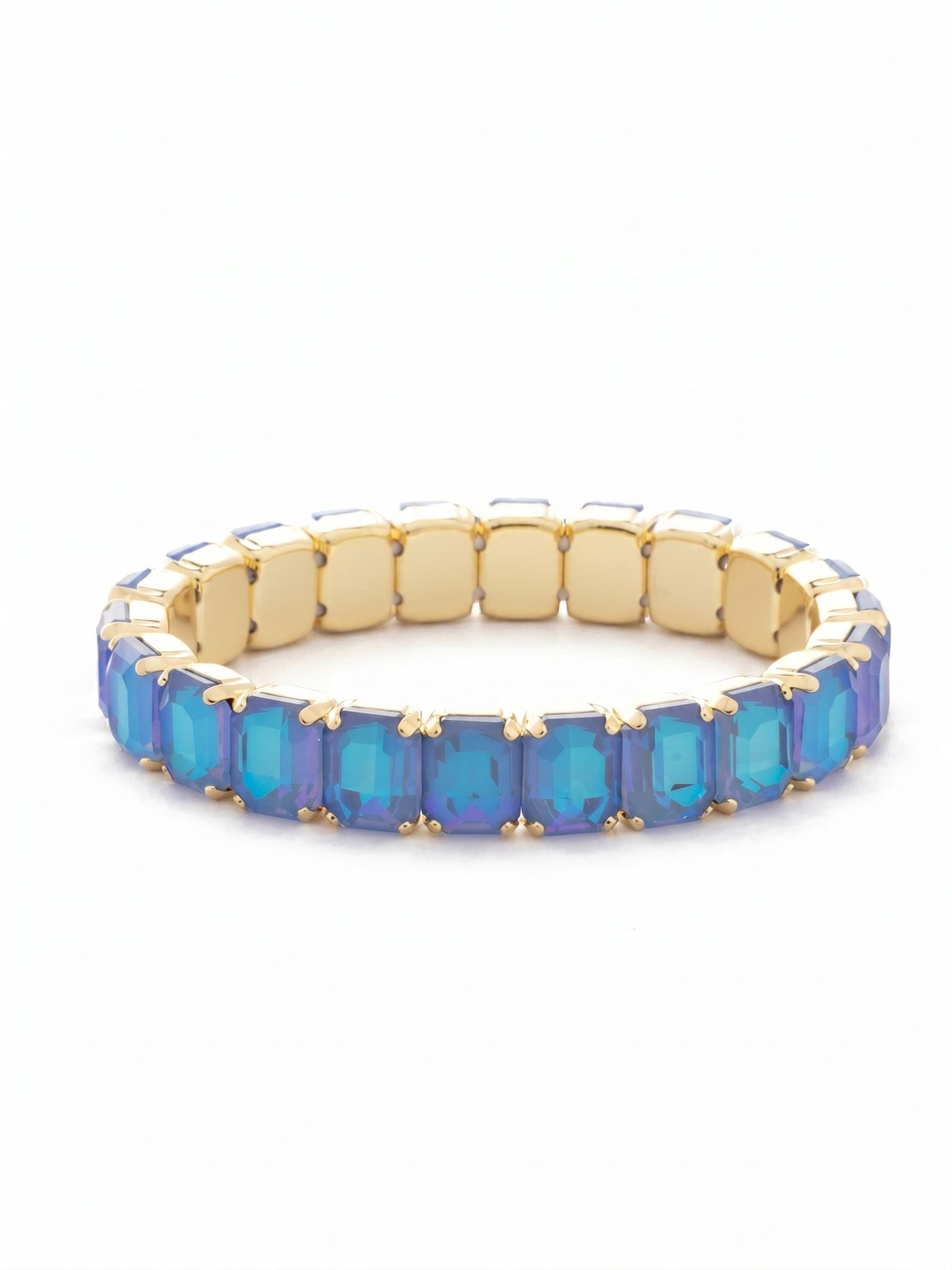 7 inch Octavia Stretch Bracelet - BFM30BGOCD - <p>A continuous band of shifting blue and violet encircles the arm. The emerald-cut crystals catch the light with every gesture, creating an unbroken line of clean geometry. Framed in warm metal, each rectangular stone offers substantial weight and visual presence. Designed as a stretch silhouette, it glides over the hand without the fuss of a clasp, instantly ready for the day ahead. The half-inch width stands beautifully on its own, while the architectural shapes make it a natural foundation for building a personalized stack.</p><ul>
<li>Continuous line of substantial emerald-cut crystals</li>
<li>Clean geometric shapes that anchor a layered stack</li>
<li>Stretch easy slip-on design</li>
<li>Protective e-coat finish for lasting wear</li>
<li>Includes signature organza pouch for gifting and travel</li>
</ul>