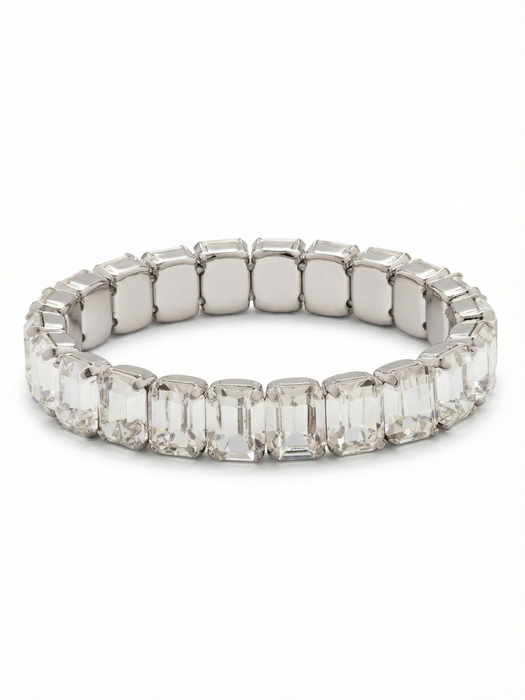 7 inch Octavia Stretch Bracelet - BFM30PDCRY - <p>The emerald cut brings a distinct geometric rhythm to this stretch bracelet. Twenty-two clear, step-cut crystals align to create a continuous band of quiet, flashing light that catches the eye with every movement of your hand. The stretch construction means it slips on easily, offering an effortless weight that moves naturally with you throughout the day. It has enough substance to wear alone as a singular, refined detail, yet the clean lines make it a highly capable starting point for building a broader, textured wrist stack.</p><ul>
<li>Continuous line of geometric emerald-cut crystals</li>
<li>Clean step-cut faceting creates long flashes of light</li>
<li>Stretch easy slip-on design</li>
<li>Protective e-coat finish for lasting wear</li>
<li>Includes signature organza pouch for gifting and travel</li>
</ul>