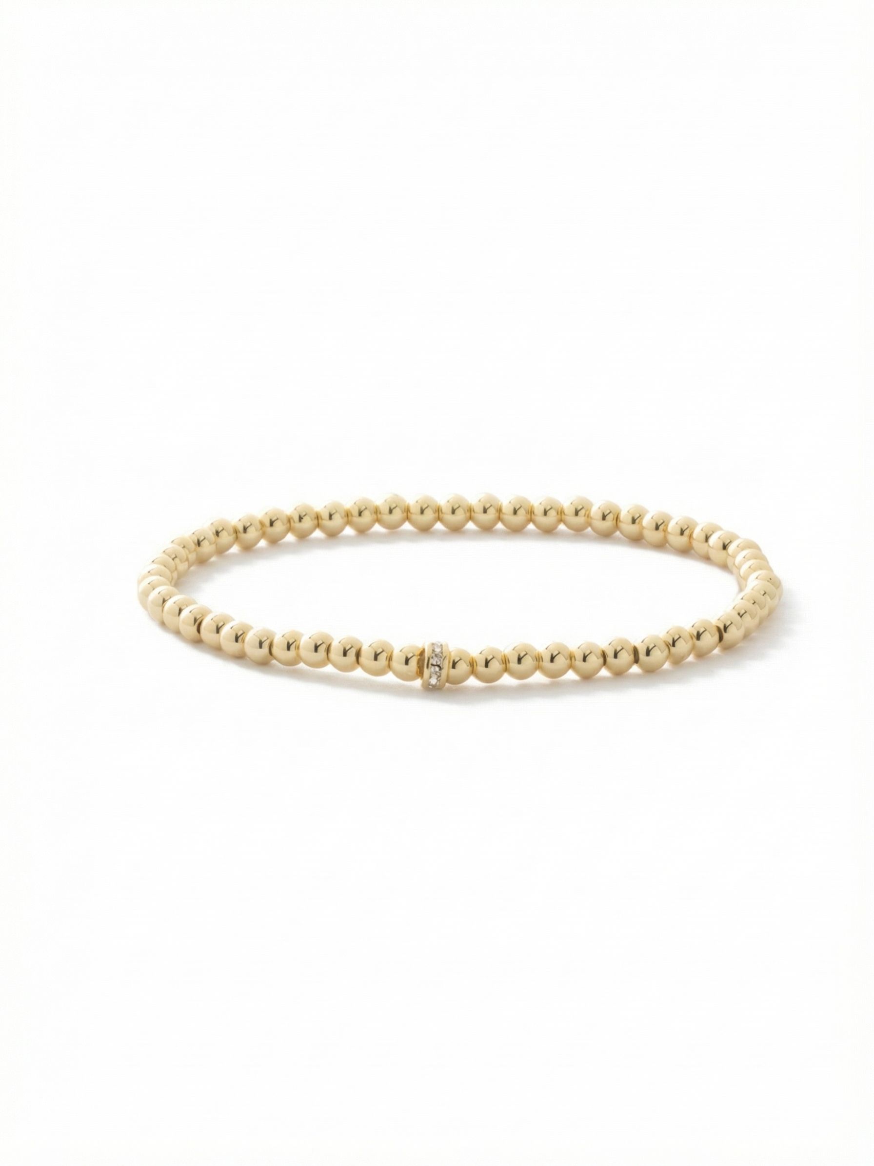 Mini Zola Charm Stretch Bracelet - BFN31BGCRY - <p>A continuous line of smooth, polished beads creates a fluid and tactile foundation for your everyday jewelry stack. Sliding on effortlessly with a flexible fit, this piece brings a warm gleam that moves with you, broken only by a single delicate crystal accent. The streamlined silhouette feels weightless and comfortable enough to live in from morning to night. It holds its own as a quiet standalone piece, but easily layers alongside your heavier cuffs and chains.</p><ul>
<li>Fluid strand of polished metal beads</li>
<li>Subtle single crystal accent bead</li>
<li>Stretch easy slip-on design</li>
<li>Protective e-coat finish for lasting wear</li>
<li>Includes signature organza pouch for gifting and travel</li>
</ul>