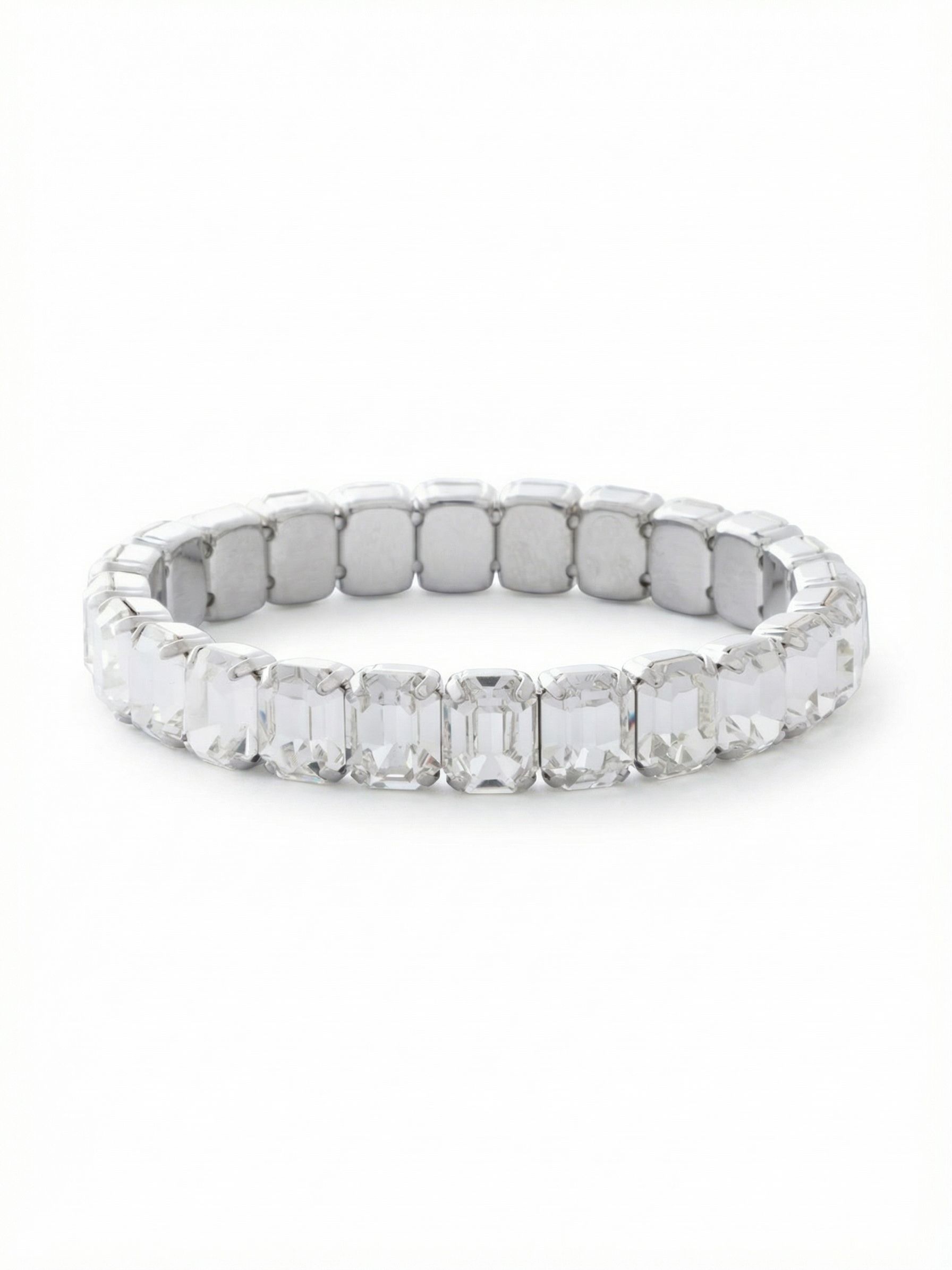 8 inch Octavia Stretch Bracelet - BFS17PDCRY - <p>Twenty-four emerald-cut clear crystals create an unbroken line of light around the arm. The step-cut faceting flashes with clean, broad reflections that feel decidedly modern in a crisp palladium setting. Because it relies on a stretch construction, there is no clasp to interrupt the continuous row of stones or slow you down when getting dressed. At eight inches, this bracelet offers a slightly more relaxed drape, giving the substantial half-inch profile plenty of room to move with you through your day.</p><ul>
<li>Continuous loop of emerald-cut stones with no clasp interruption</li>
<li>Large step-cut faceting delivers broad flashes of light</li>
<li>Stretch easy slip-on design</li>
<li>Protective e-coat finish for lasting wear</li>
<li>Includes signature organza pouch for gifting and travel</li>
</ul>