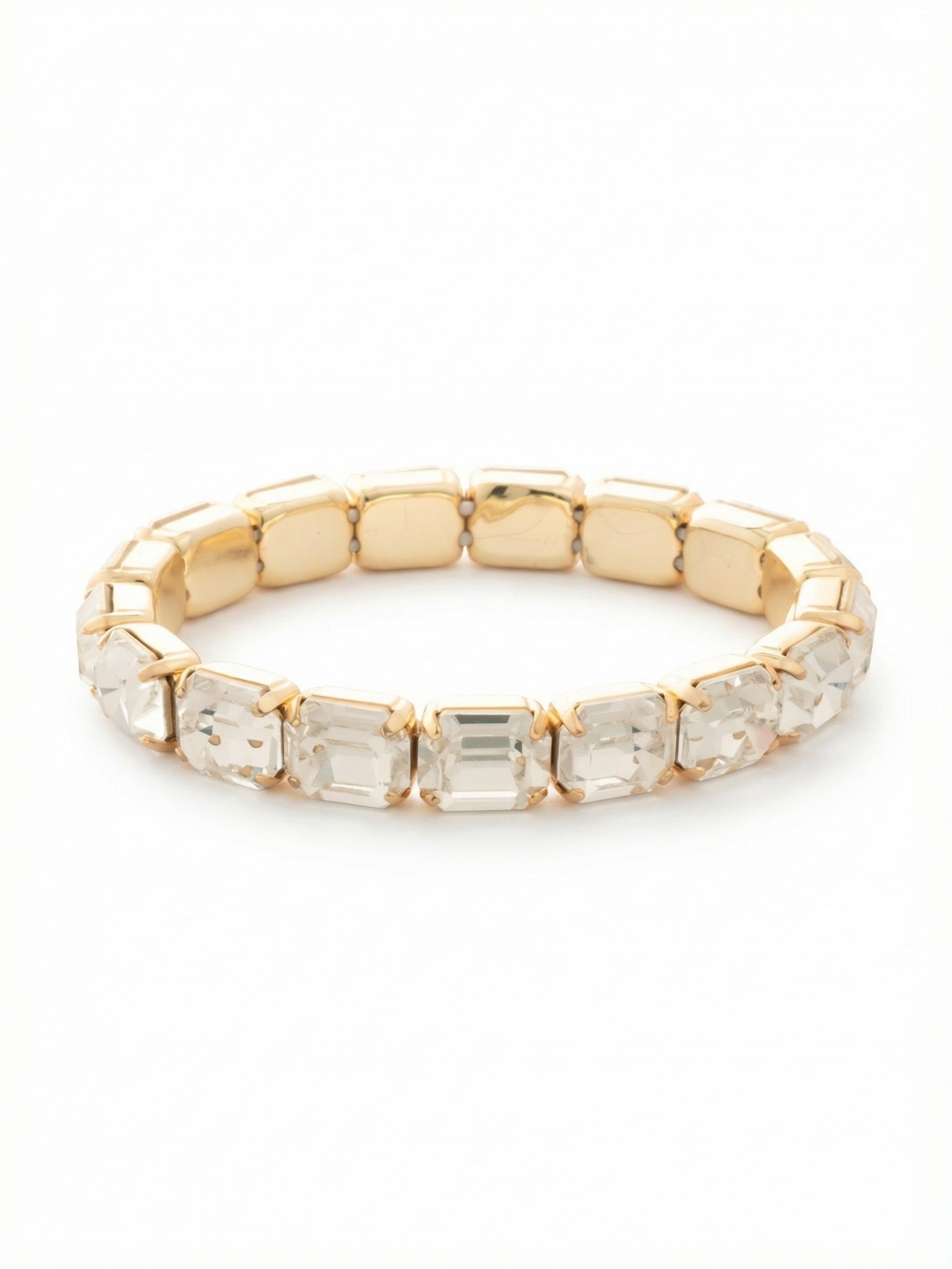 7 Inch Easton Emerald Cut Stretch Bracelet - BFS30BGCRY - <p>A continuous line of architectural emerald-cut crystals wraps the wrist with clean, structural flashes of light. The step-cut facets catch the sun in long glints, set closely together to create an unbroken band of clarity. Built on a flexible base, it rolls effortlessly over the hand without the fuss of a clasp, adapting easily to your movement. It holds enough presence to wear alone, yet its geometric lines make it a strong grounding piece for a layered stack.</p><ul>
<li>Continuous line of emerald-cut crystals with deep step-cut facets</li>
<li>Flexible structural design that slips easily over the hand</li>
<li>Stretch easy slip-on design</li>
<li>Protective e-coat finish for lasting wear</li>
<li>Includes signature organza pouch for gifting and travel</li>
</ul>