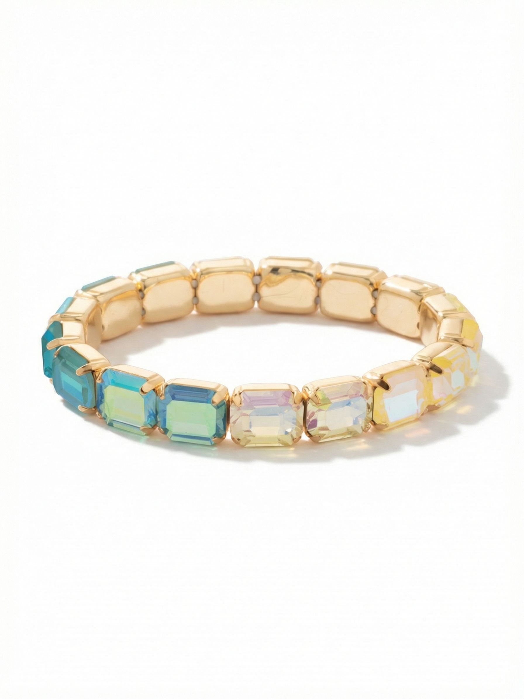 7 Inch Easton Emerald Cut Stretch Bracelet - BFS30BGCSD - <p>A gradient of warm topaz and cool aquamarine crystals creates an effortless wash of color. Cut in a sleek architectural emerald shape, the stones deliver broad flashes of light rather than scattered sparkle. The stretch construction means there is no clasp to fasten, slipping easily over your hand and adapting to your movements. Bright gold-tone settings frame a clean continuous line around your arm, making this piece just as compelling worn alone as it is anchoring a textured stack.</p><ul>
<li>Continuous line of emerald-cut crystals</li>
<li>Gradient palette shifting from warm topaz to cool blues</li>
<li>Stretch easy slip-on design</li>
<li>Protective e-coat finish for lasting wear</li>
<li>Includes signature organza pouch for gifting and travel</li>
</ul>