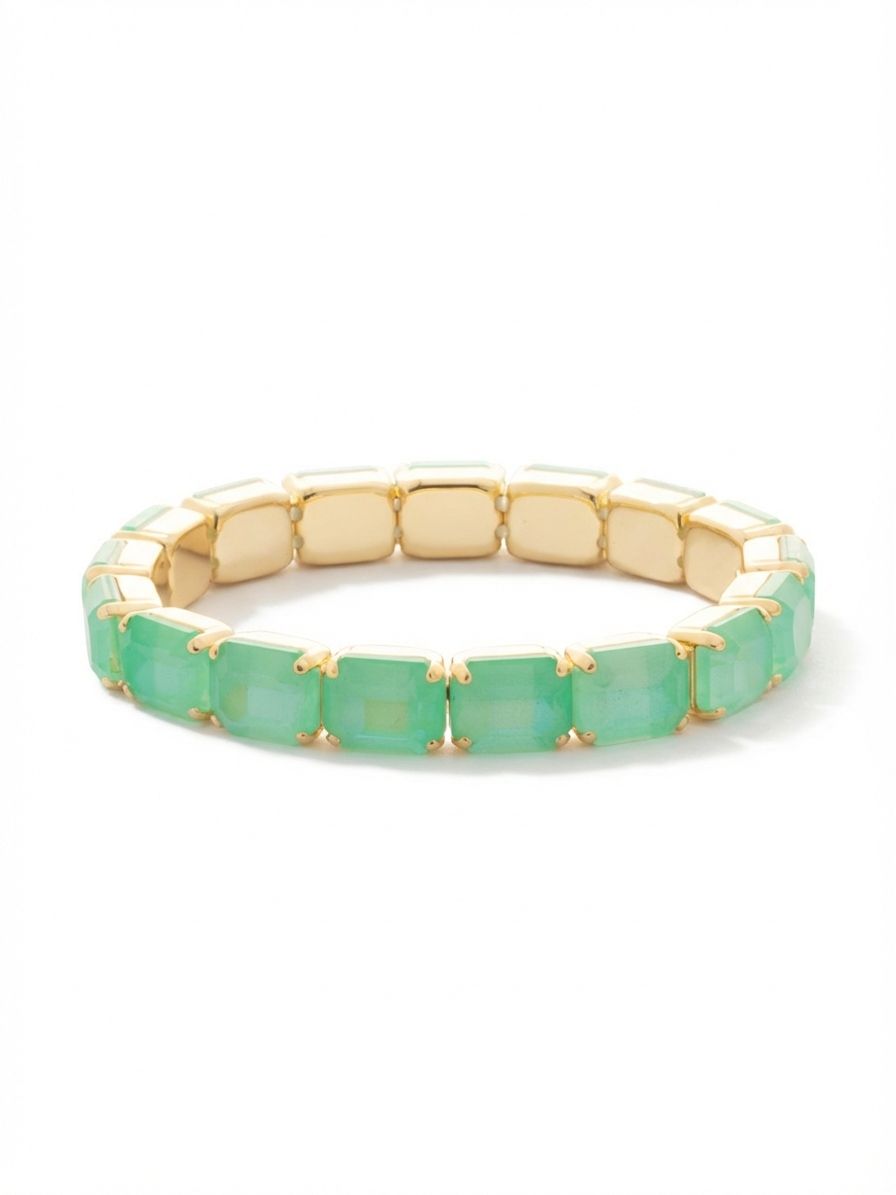 7 Inch Easton Emerald Cut Stretch Bracelet - BFS30BGMND - <p>An unbroken line of soft translucent color, this stretch bracelet rolls easily over your hand without the need to fuss with a clasp. Emerald-cut crystals frame the wrist in pale mint green, their stepped facets catching the light with a quiet, geometric rhythm. Set in warm gold, it brings a clean architectural element to a bare forearm or slips naturally into a daily stack. The flexible construction adapts to your movement, offering a comfortable fit that moves effortlessly with you.</p><ul>
<li>Continuous row of large emerald-cut crystals creates a modern geometric profile</li>
<li>Internal stretch cord allows the piece to roll easily over the hand</li>
<li>Stretch easy slip-on design</li>
<li>Protective e-coat finish for lasting wear</li>
<li>Includes signature organza pouch for gifting and travel</li>
</ul>