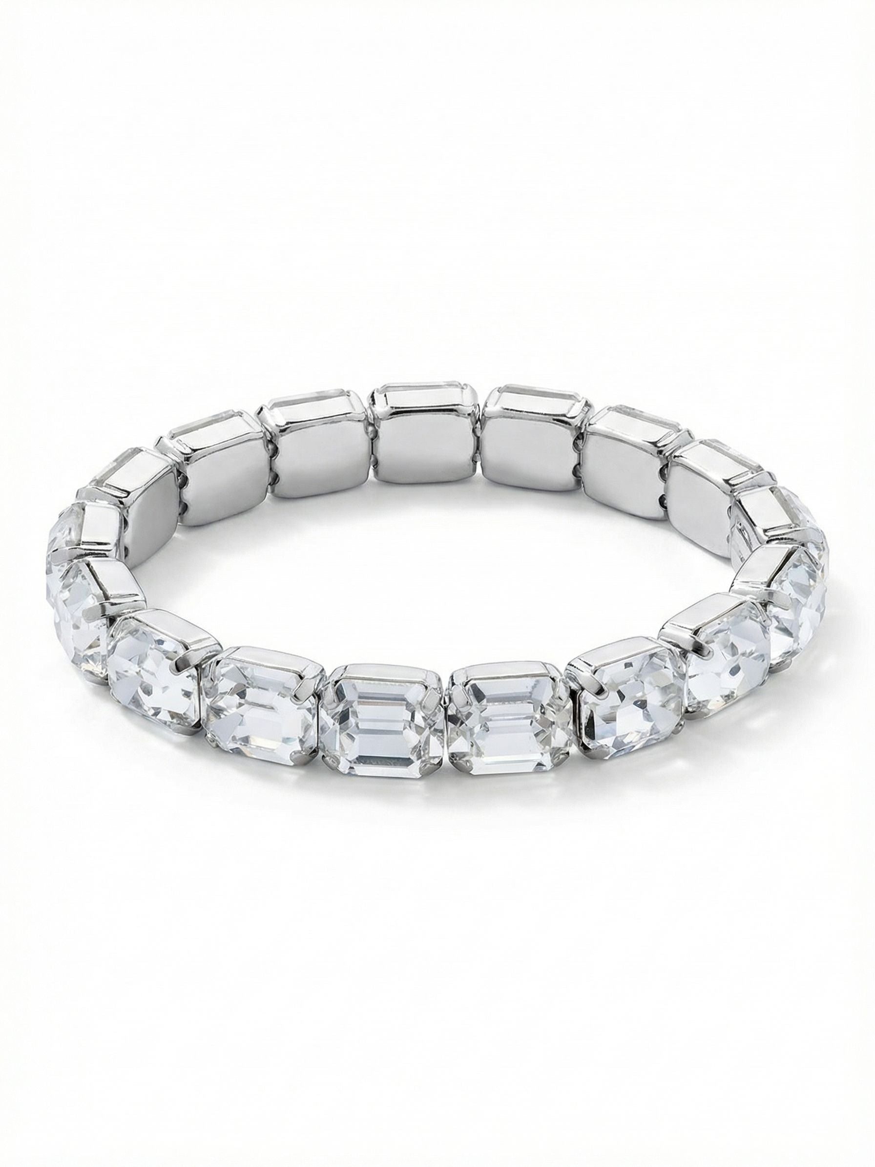 7 Inch Easton Emerald Cut Stretch Bracelet - BFS30PDCRY - <p>A continuous band of clear, emerald-cut crystals circles the arm in the Easton stretch bracelet. The long, linear step facets create deep, mirrored reflections rather than scattered sparkle, giving the piece a distinctively architectural presence. Built on a flexible base, the bracelet glides on easily and adapts comfortably as you move. It carries enough visual weight to wear alone, while its clean geometric lines make it an excellent anchor to balance a layered wrist stack.</p><ul>
<li>Continuous band of geometric step-cut crystals</li>
<li>Flexible foundation for effortless wear</li>
<li>Stretch easy slip-on design</li>
<li>Protective e-coat finish for lasting wear</li>
<li>Includes signature organza pouch for gifting and travel</li>
</ul>