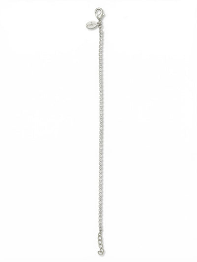 Mini Marnie Tennis Bracelet - BFS32PDCRY - <p>A whisper-thin line of continuous crystal, the Mini Marnie brings a delicate sensibility to the classic tennis bracelet. The fine rhinestone chain catches the light with every movement of your hand, offering a subtle but distinct presence. It works beautifully as a quiet standalone accent or an effortless base layer for building a custom stack. The fluid construction flexes naturally with your daily routine, and an integrated extension chain lets you tailor the drape exactly how you prefer it.</p><ul>
<li>Ultra-fine continuous crystal line</li>
<li>Fluid rhinestone chain construction for effortless stacking</li>
<li>Lobster claw clasp</li>
<li>3/4-inch adjustable extension chain</li>
<li>Protective e-coat finish for lasting wear</li>
<li>Includes signature organza pouch for gifting and travel</li>
</ul>